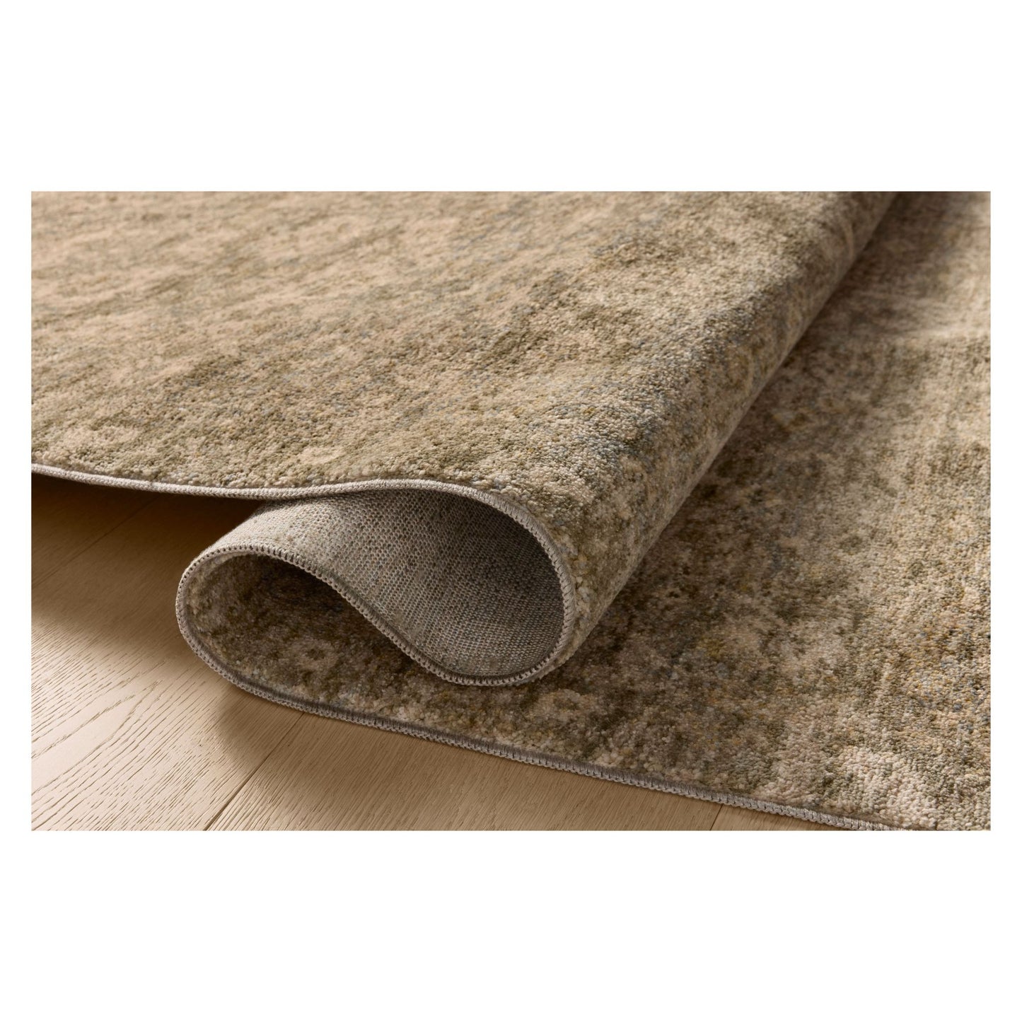 Junie Lagoon Natural Rug shown rolled over itself