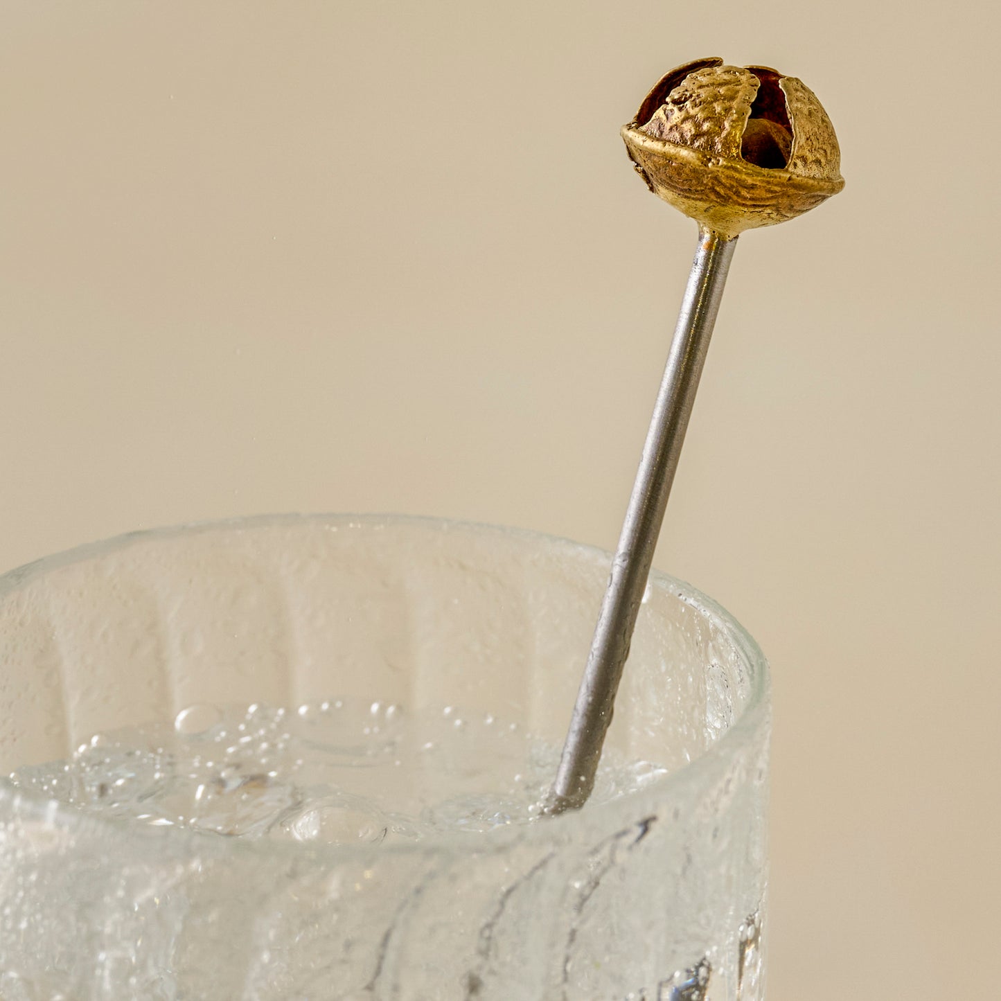 Brass Jingle Bell Cocktail Stirrers up close