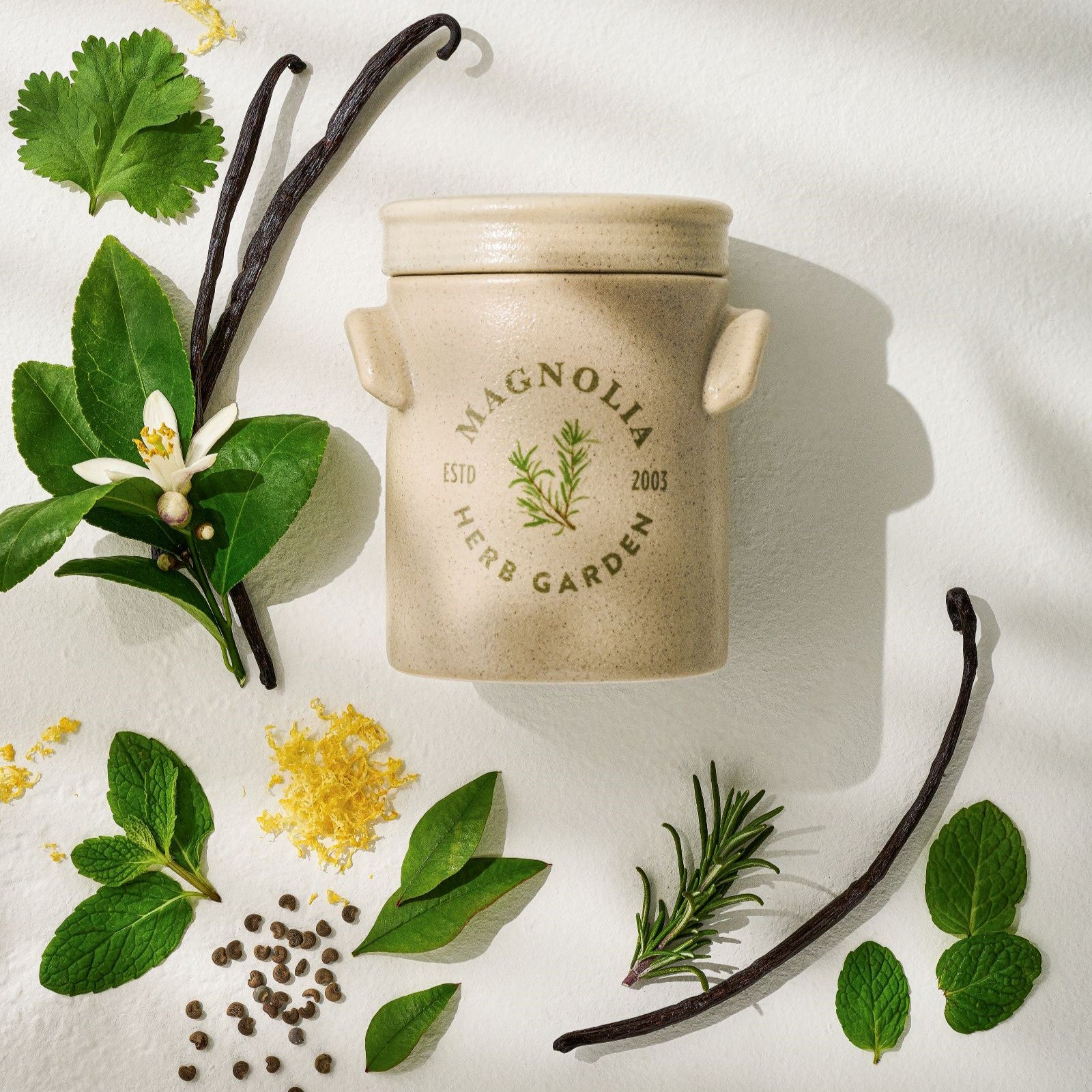 herb garden candle shows scent notes including mandarin leaf and rosemary
