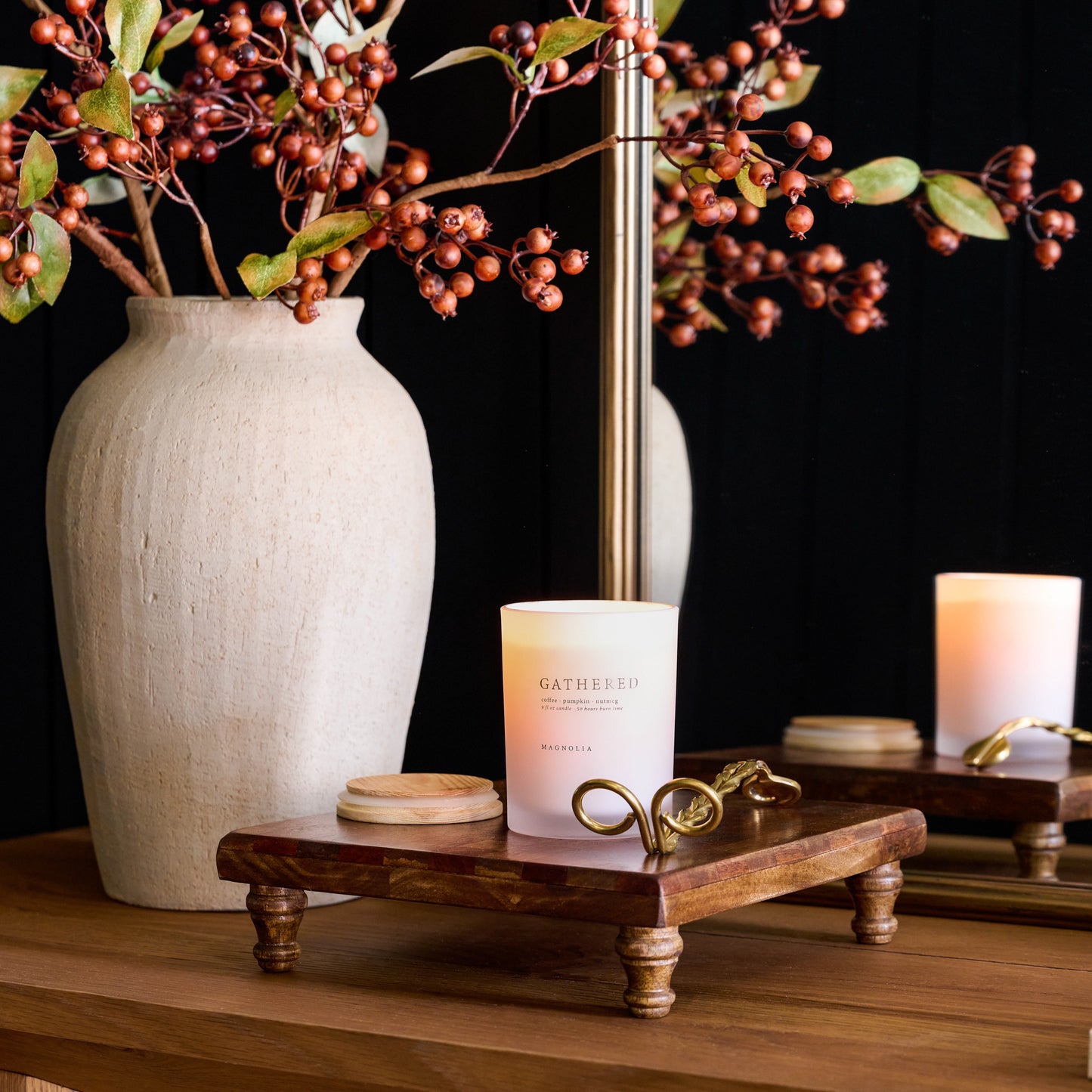 Magnolia Gathered Candle on a serving board