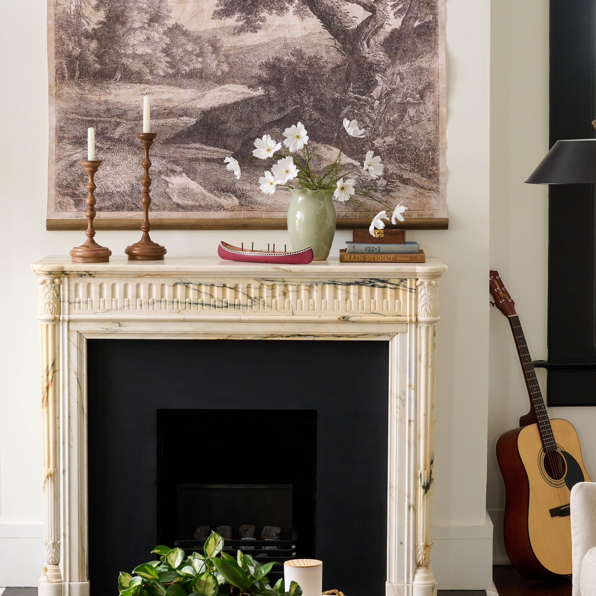 Large Nancy Green Scalloped Ceramic Vase on a fireplace mantle with flowers in it
