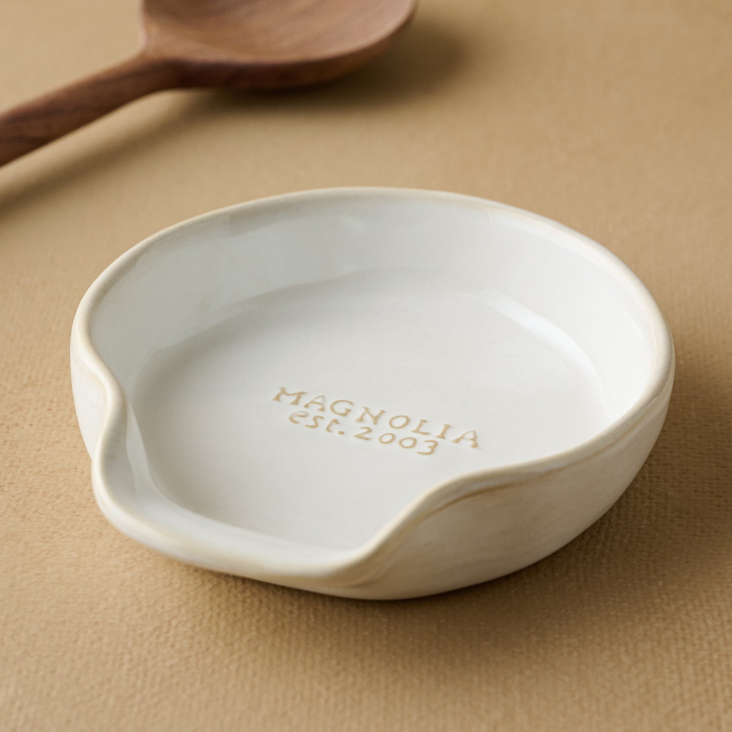 Magnolia Est. Spoon Rest with spoon in the background