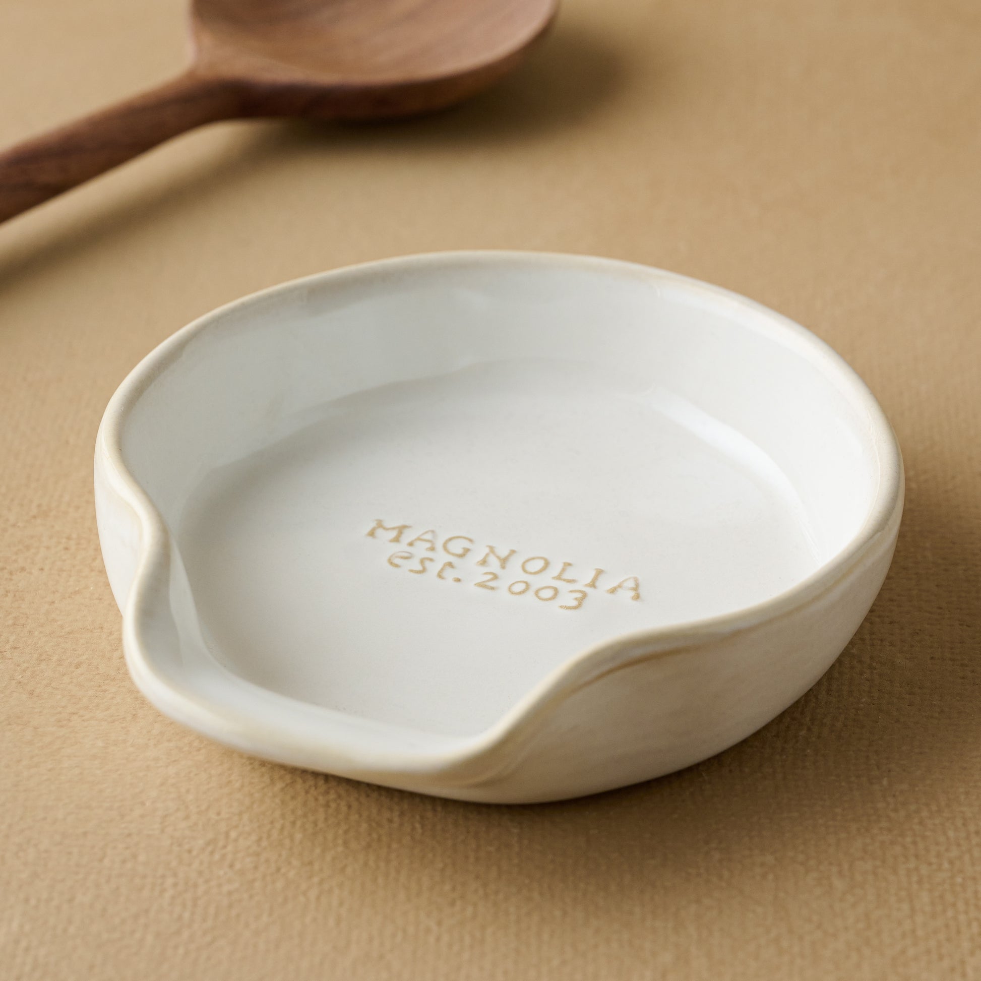 Magnolia Est. Spoon Rest with spoon in the background