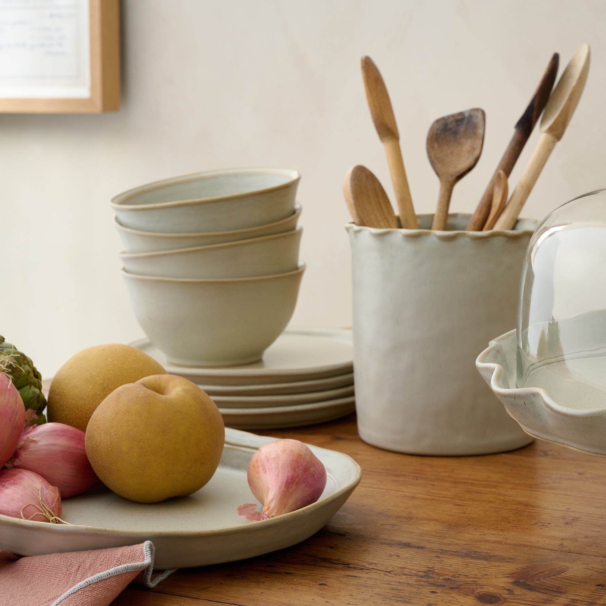 French Grey Ruffle Utensil Crock with utensils on a counter
