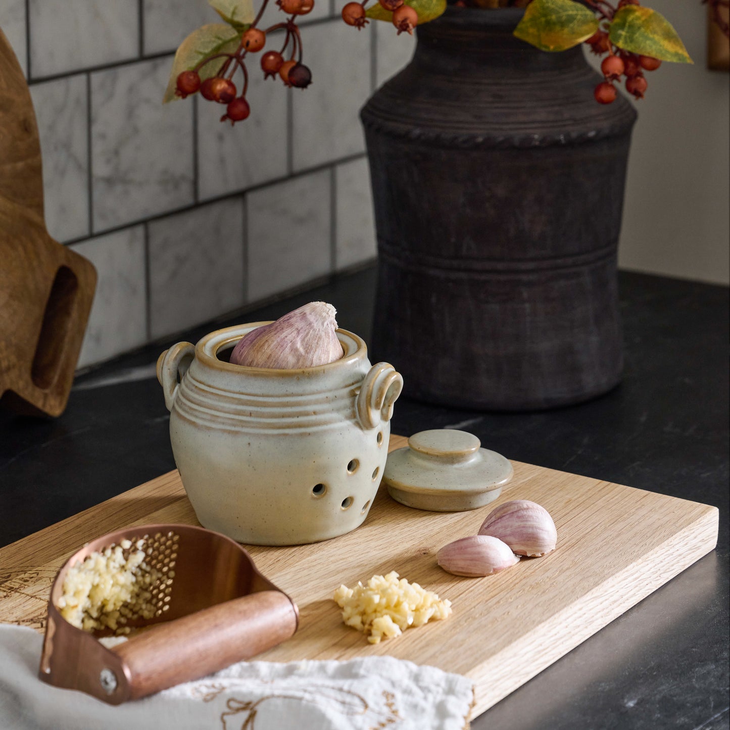 French Grey Garlic Keeper shown on serving board with garlic
