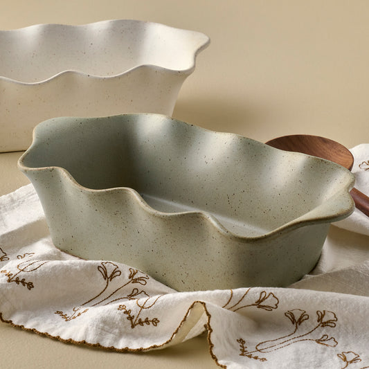 Loden Green Scalloped Loaf Pan shown with tea towel and serveware