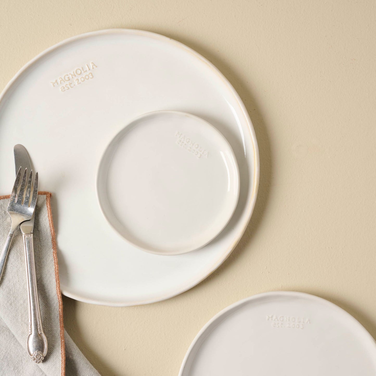 Magnolia Est. Plates in all 3 sizes shown with silverware
