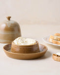 French Grey Reduction Fire Butter Dish with butter inside next to a plate of bread