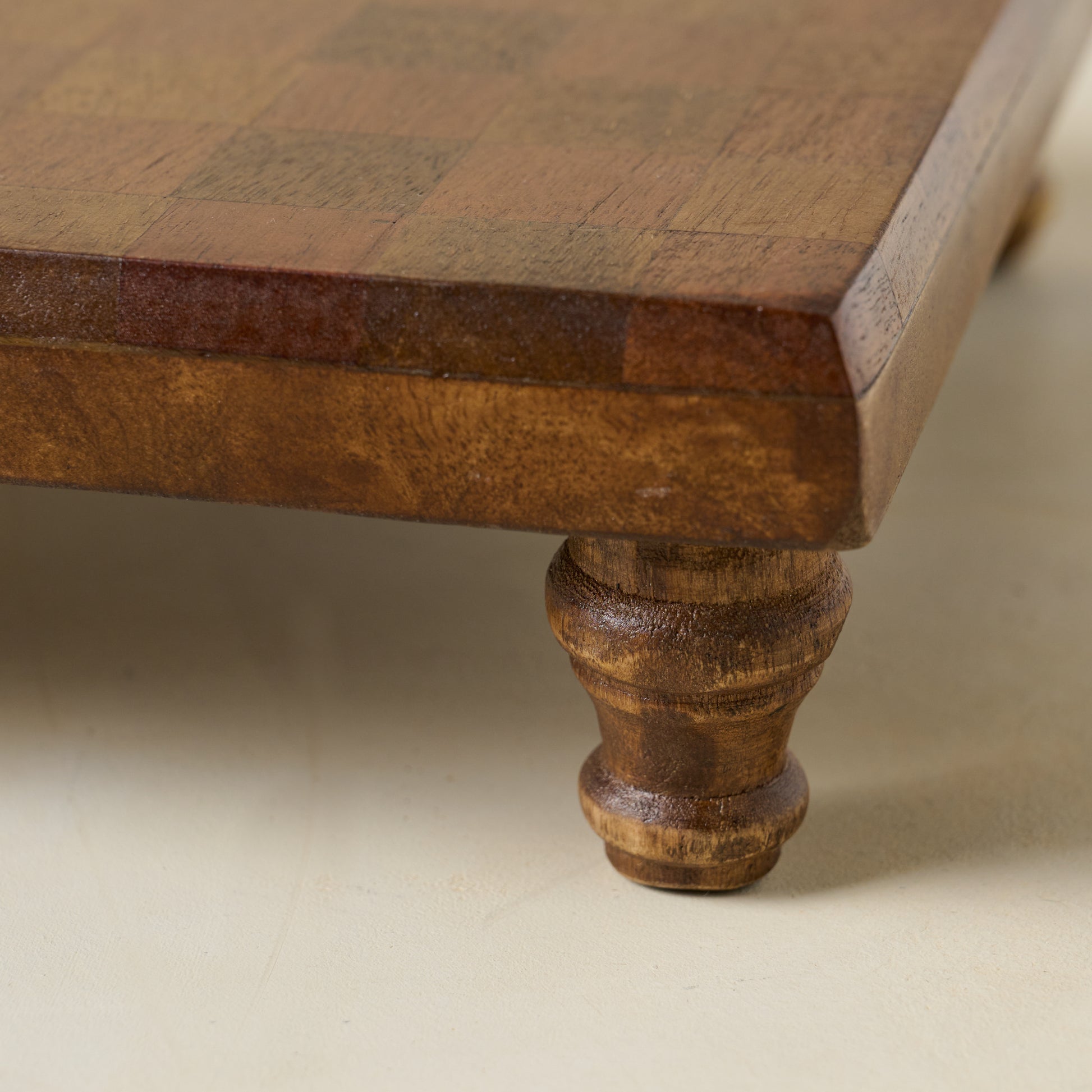 Checkered Wood Riser close up of leg on riser