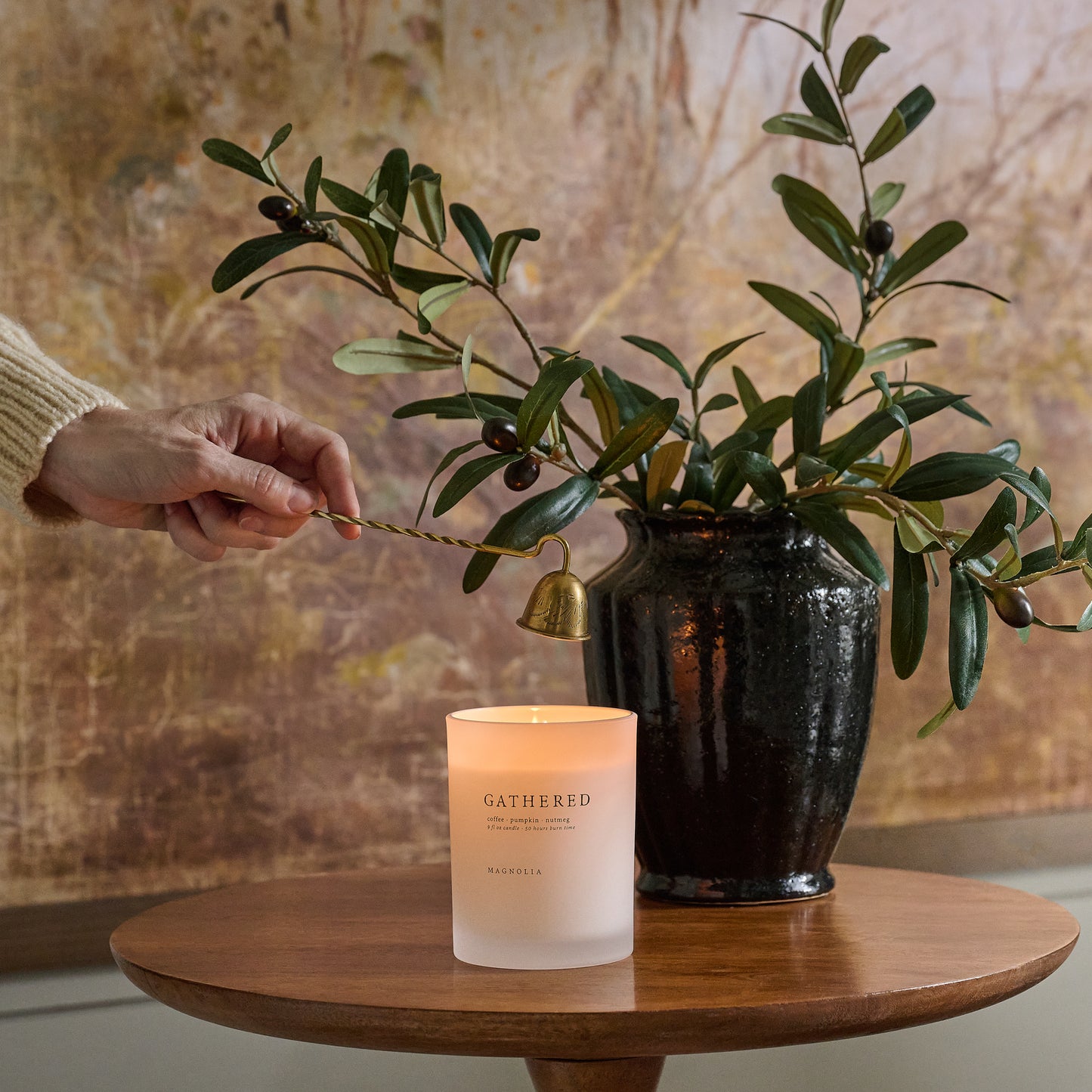 Magnolia Gathered Candle shown being put out