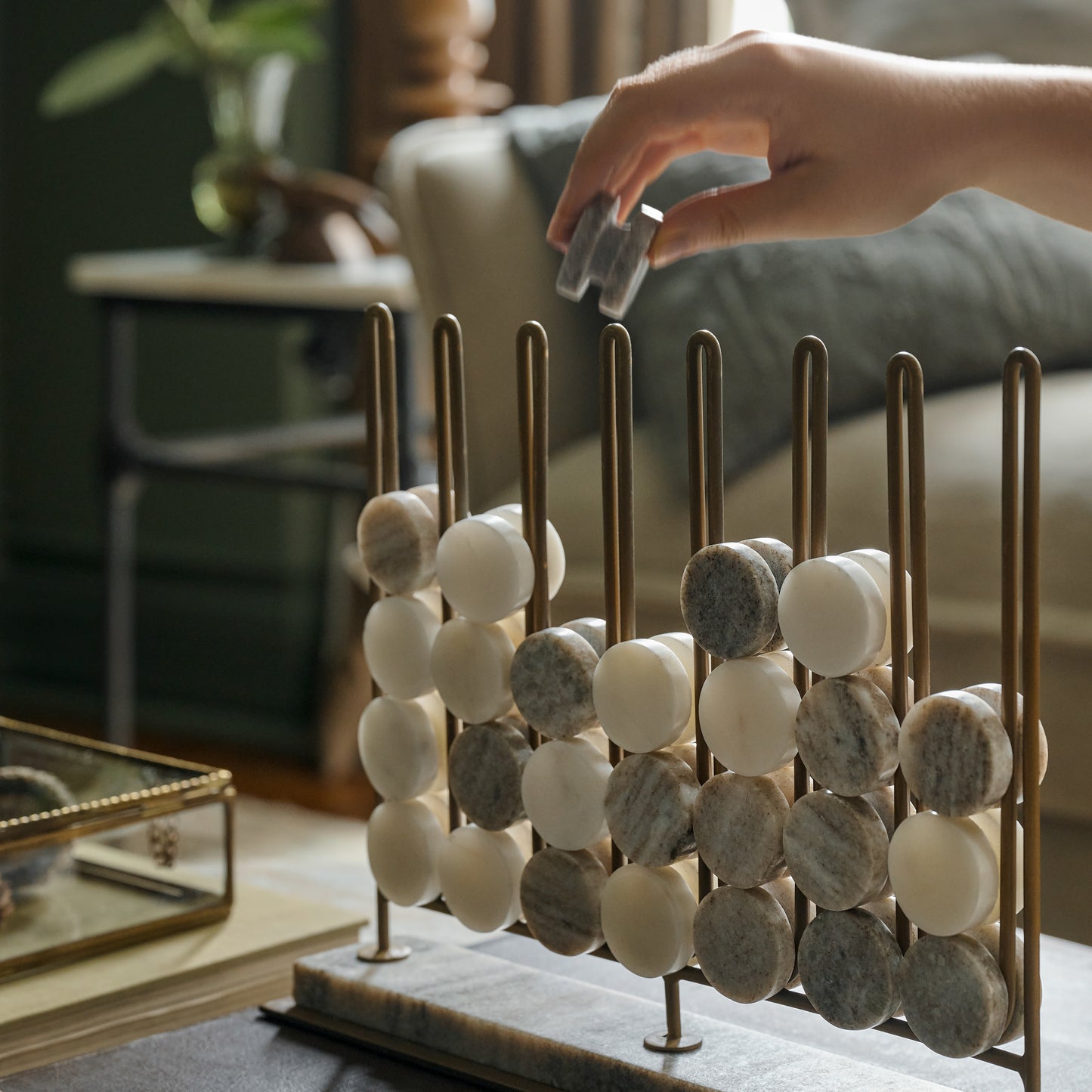Marble Four In a Row Decorative Game shown being played