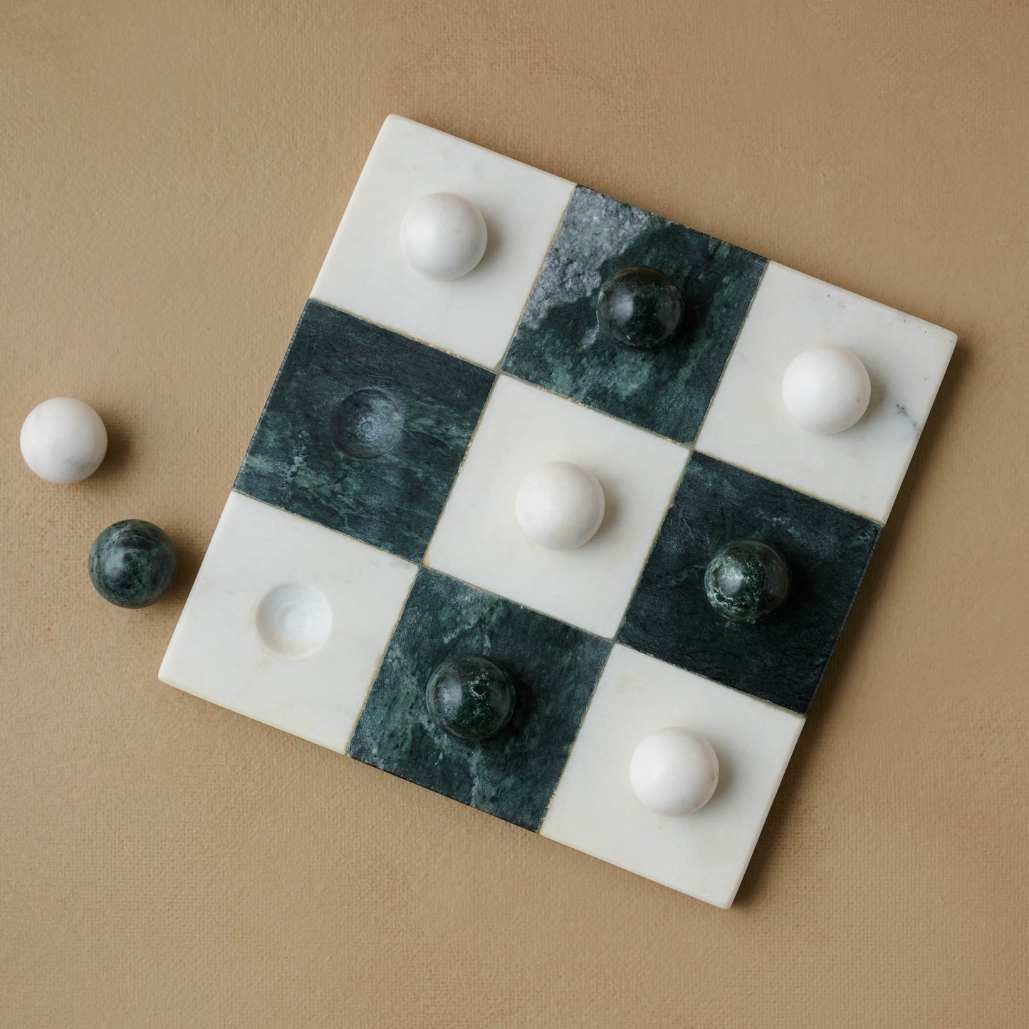 Green and White Marble Tic Tac Toe with two marble pieces on the side