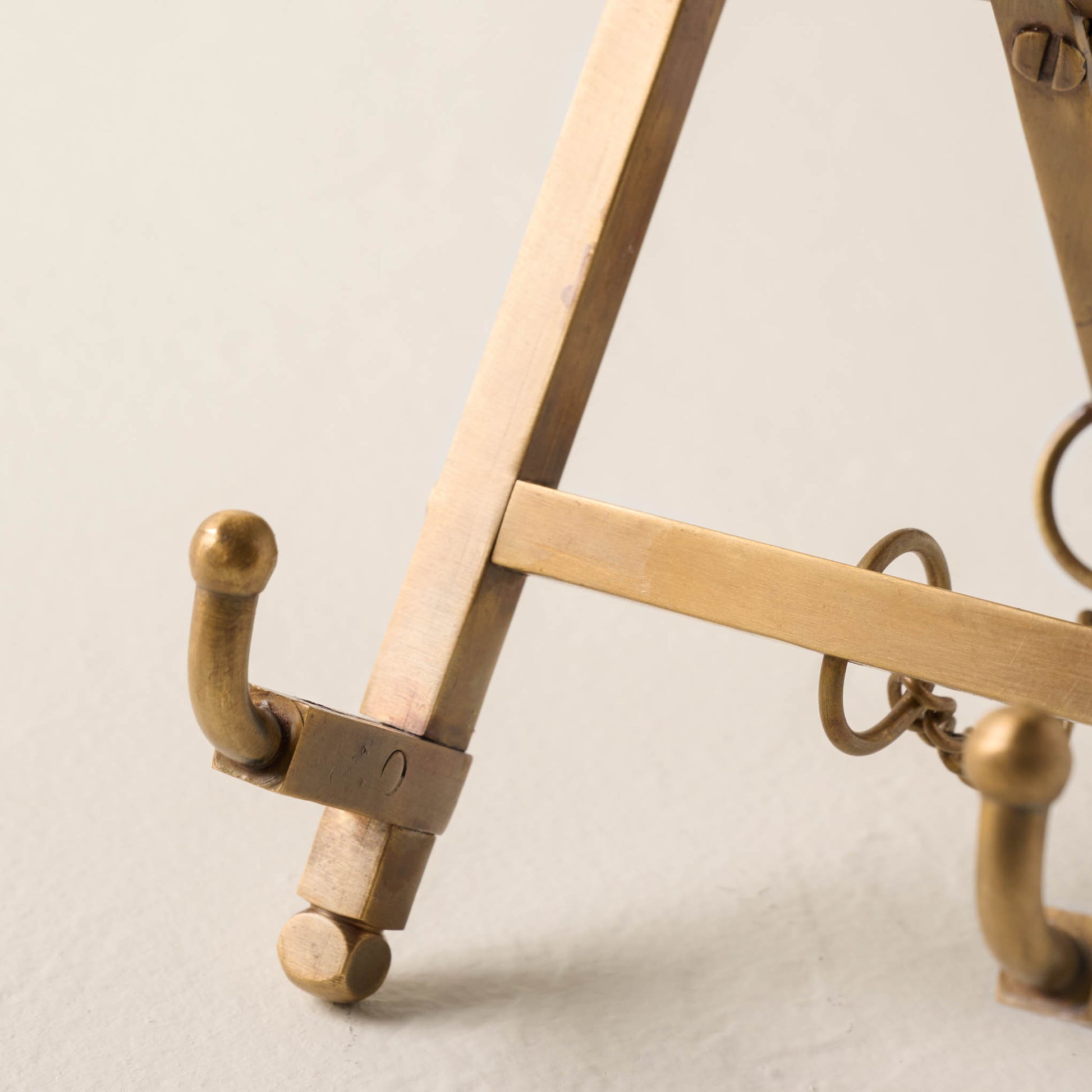 detailed view of brass shelf easel