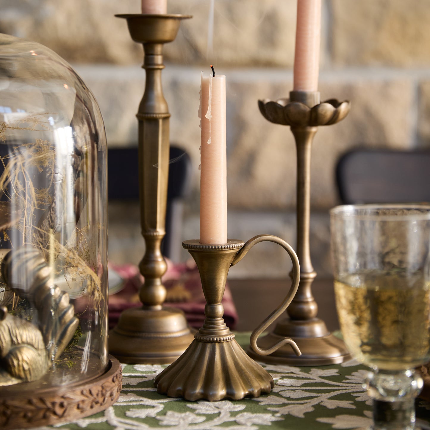 Anna Antique Brass Taper Holder on a dining table