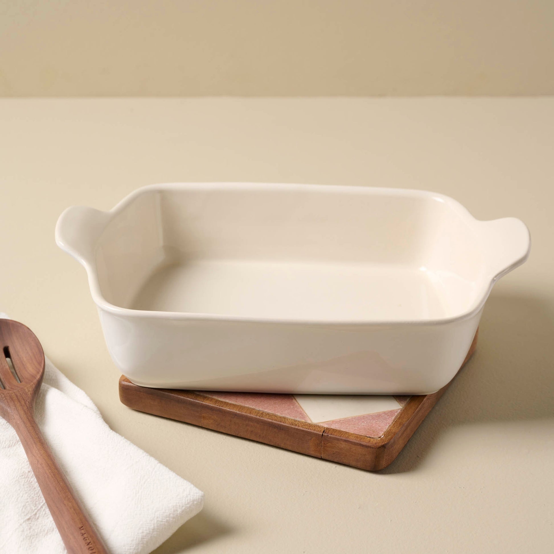 Carmella Checkered Marble Trivet with a baking dish on top
