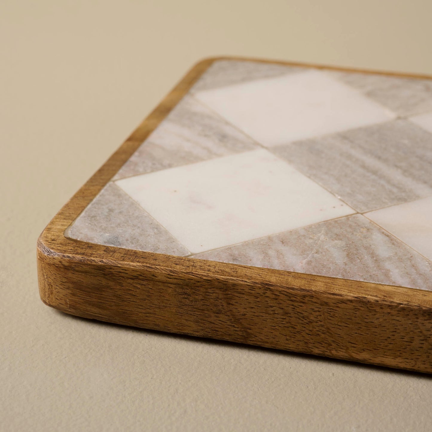 Everett Checkered Marble Trivet at a low angle