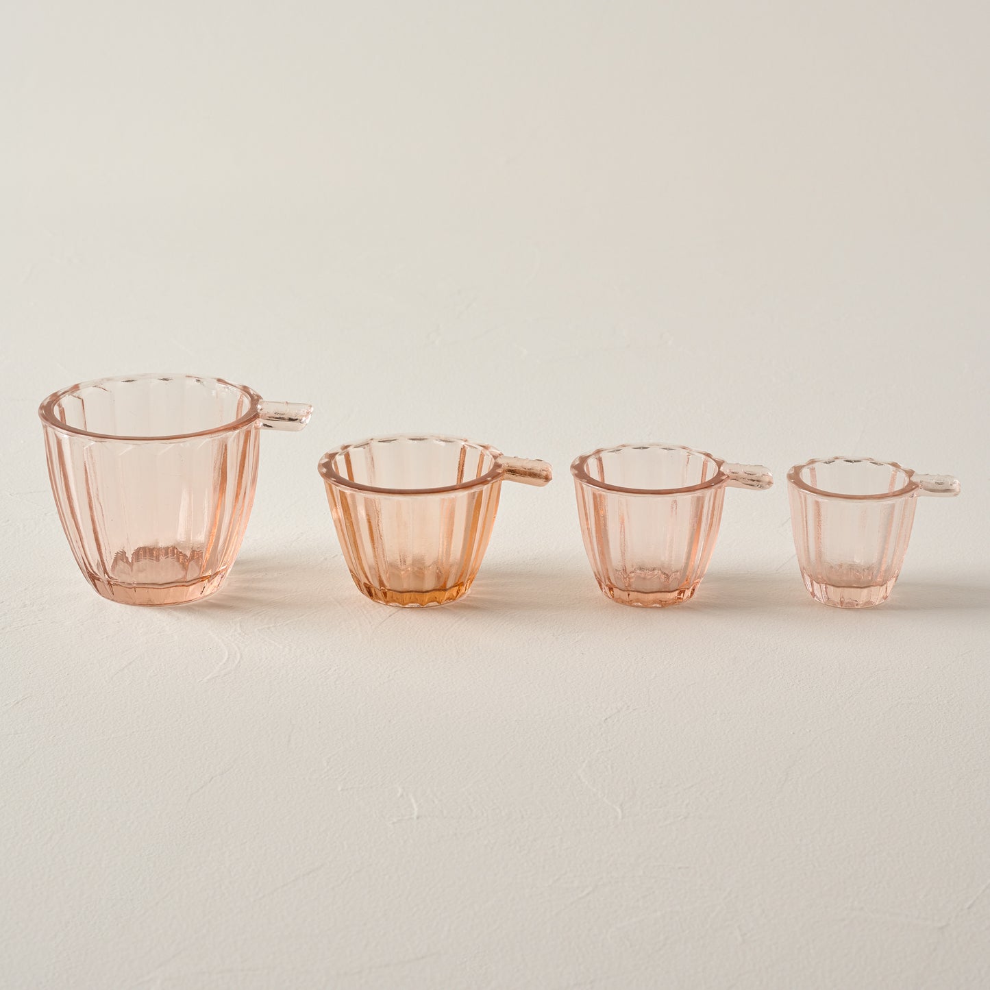 Blush Glass Measuring Cup Set in a line showing all four sizes