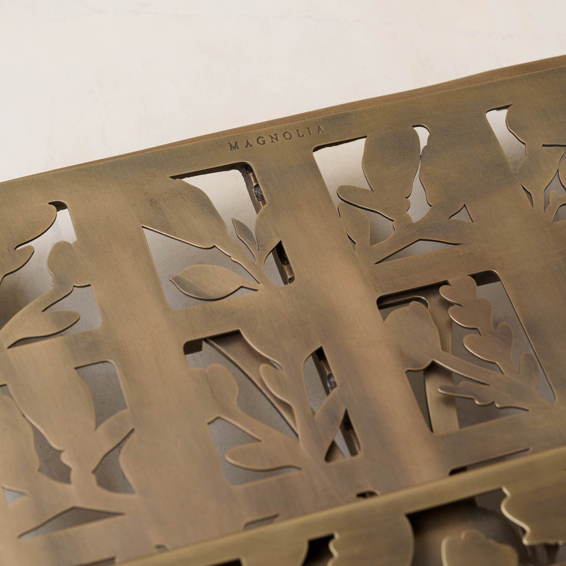 Antique Brass Shadow Floral Cookbook Stand close up showing magnolia logo embossing