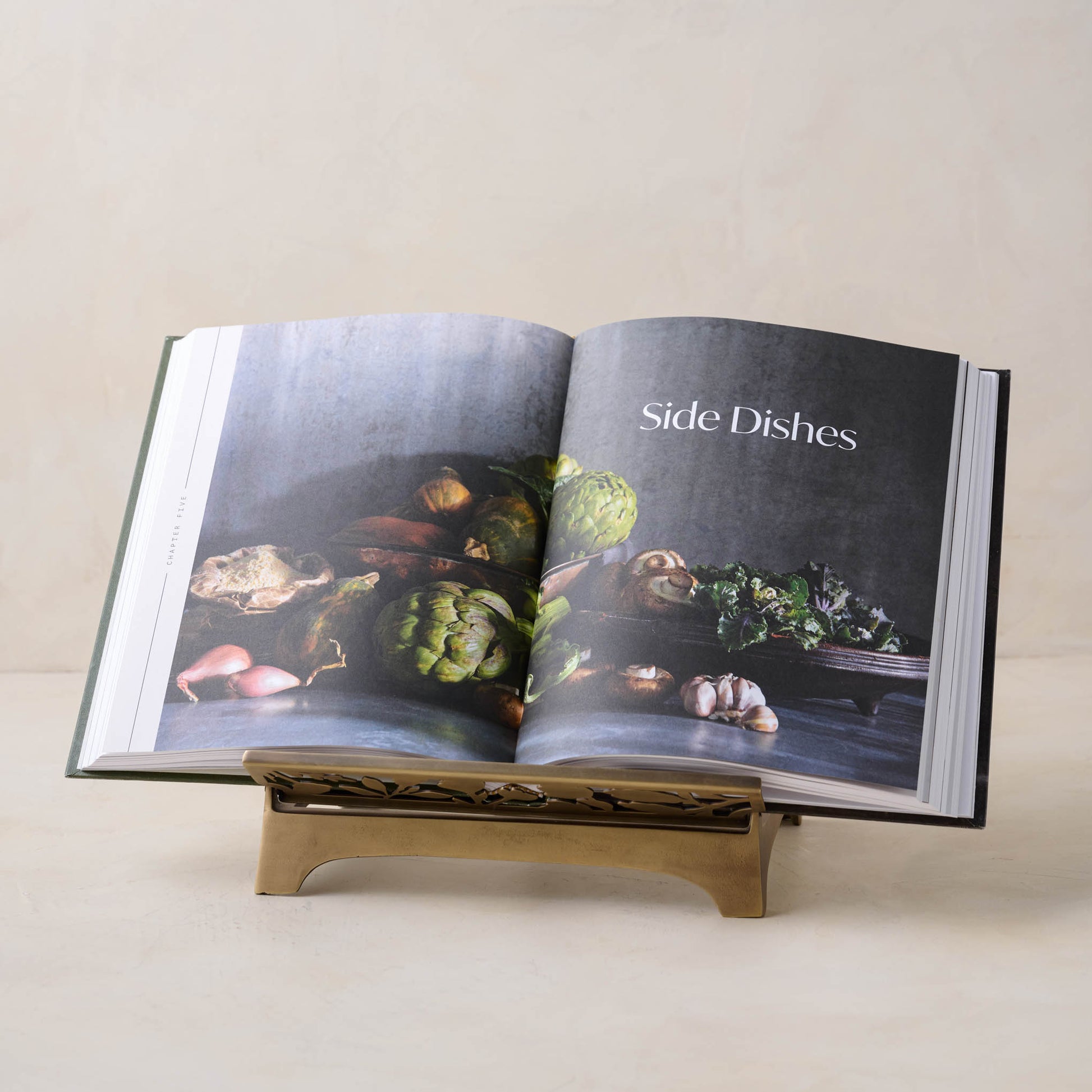 Antique Brass Shadow Floral Cookbook Stand with a cookbook open to a page titled "side dishes"
