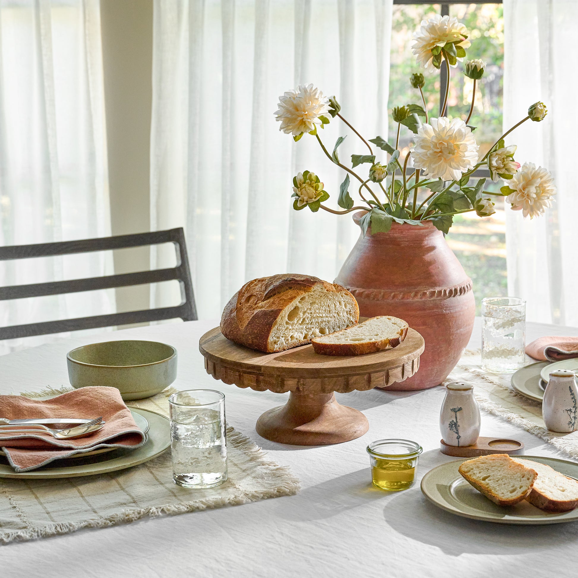 Antiqued Wood Scalloped Cake Stand in a room