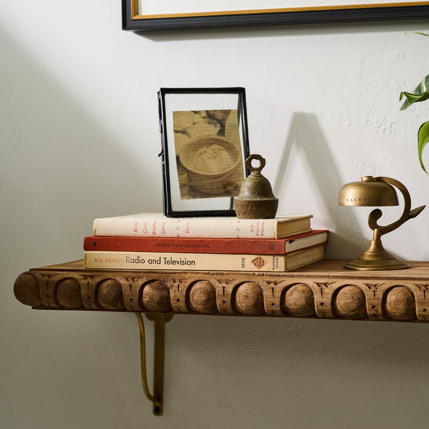 Griffin Hand Carved Wood Shelf on a wall close up