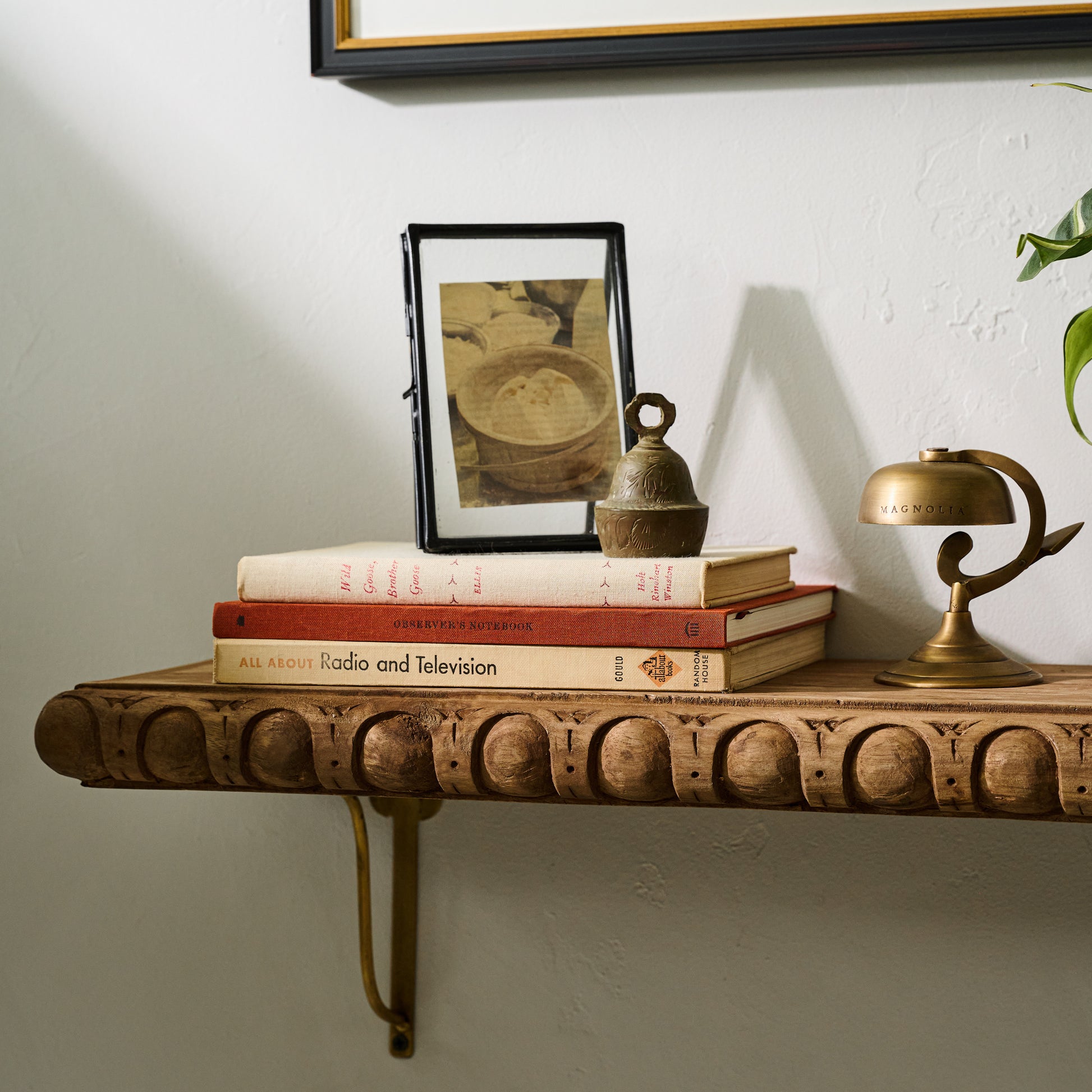 Griffin Hand Carved Wood Shelf on a wall close up