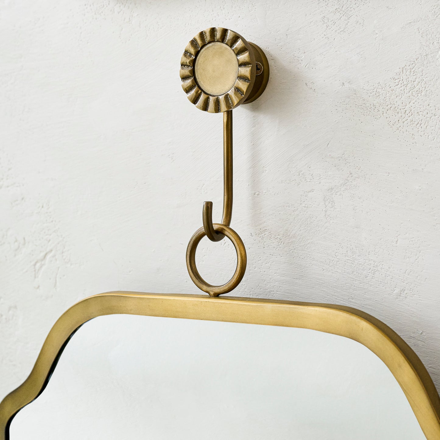 Justine Brass Hanging Mirror close up of hook holding mirror