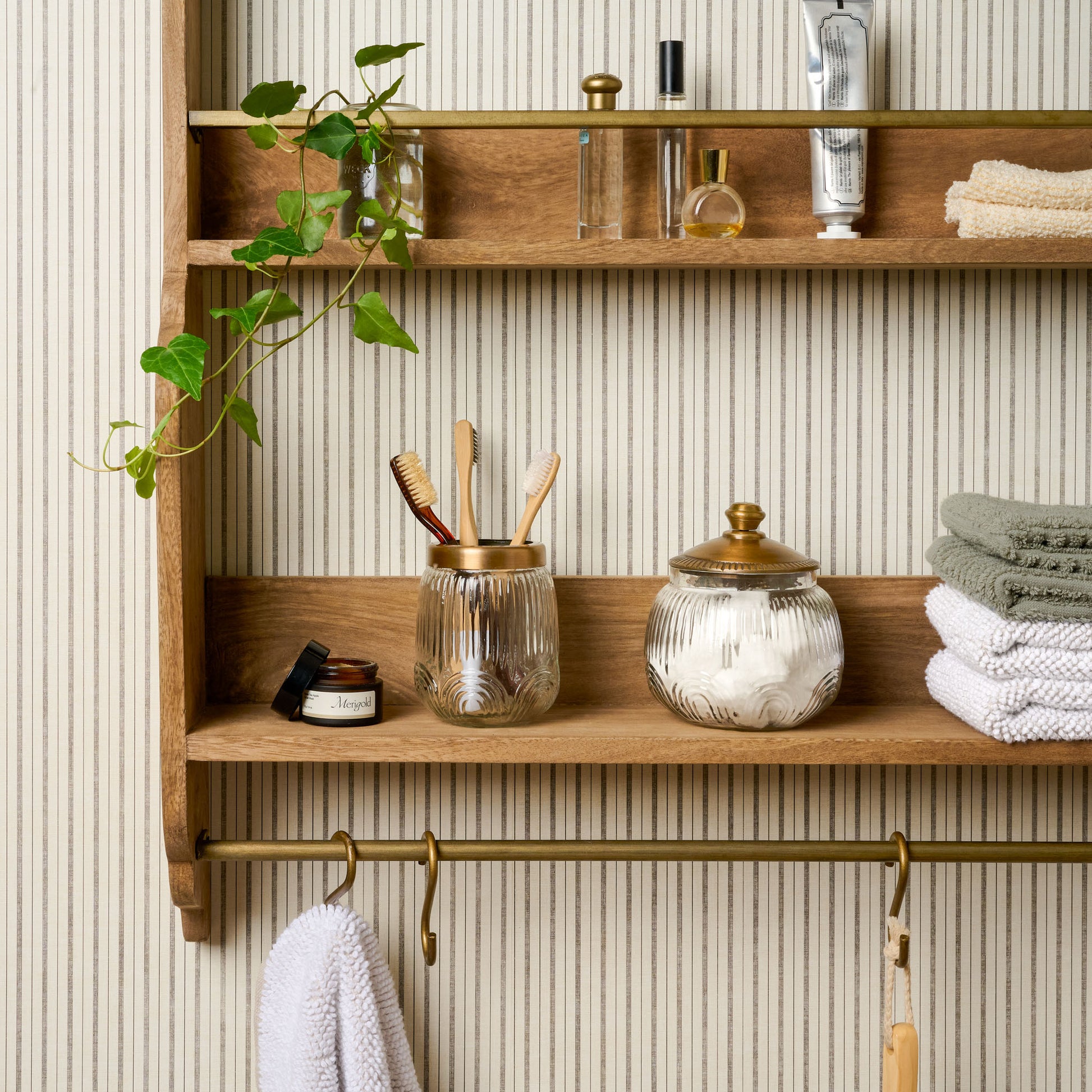 Hannon Wood and Brass Display Shelf with bathroom items on shelves
