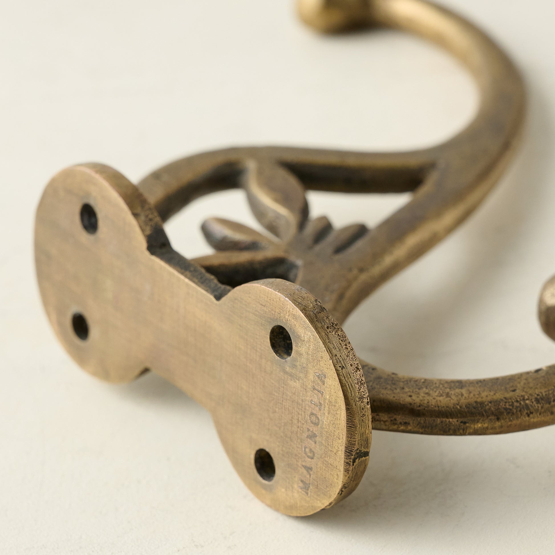 Antique Brass Floral Hook close up of screw holes