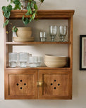 Vaughn Antiqued Wood Shelf with Doors shown with dishes