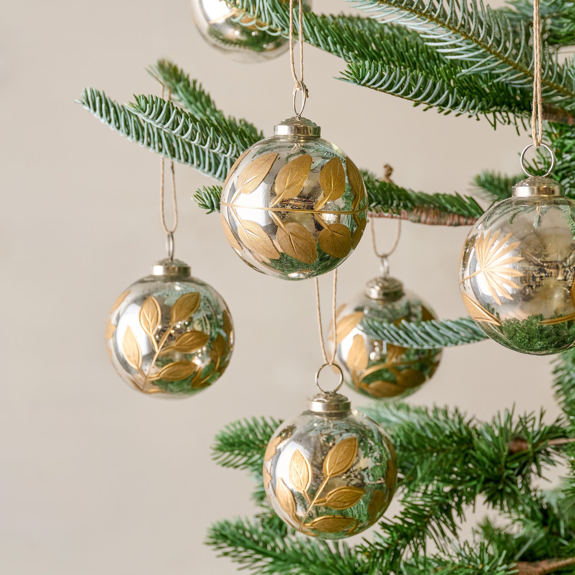 Small Mercury Glass and Gold Botanical Ornament Set of Six shown on tree