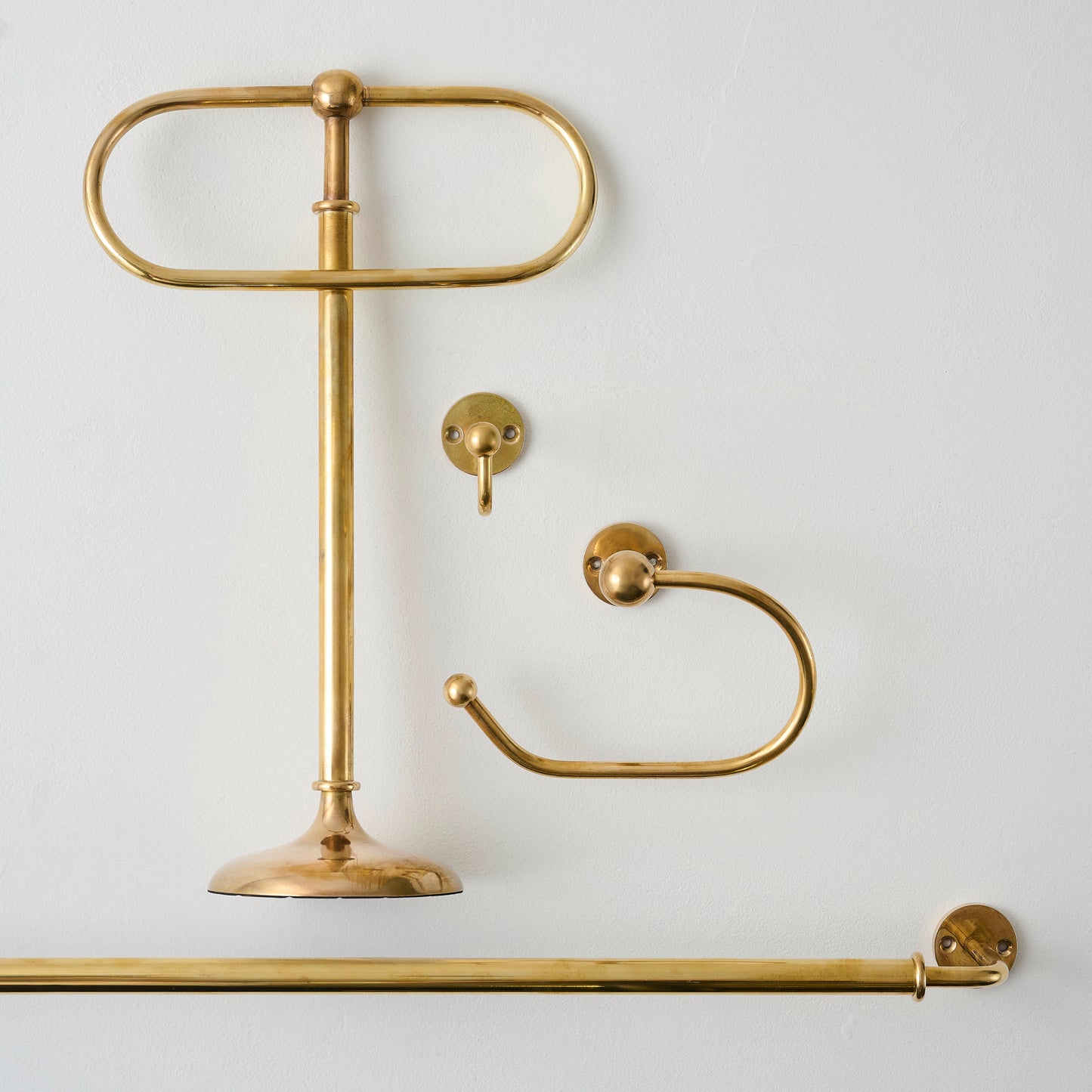 Jules Brass Towel Stand shown with hook, bar, and toilet paper holder