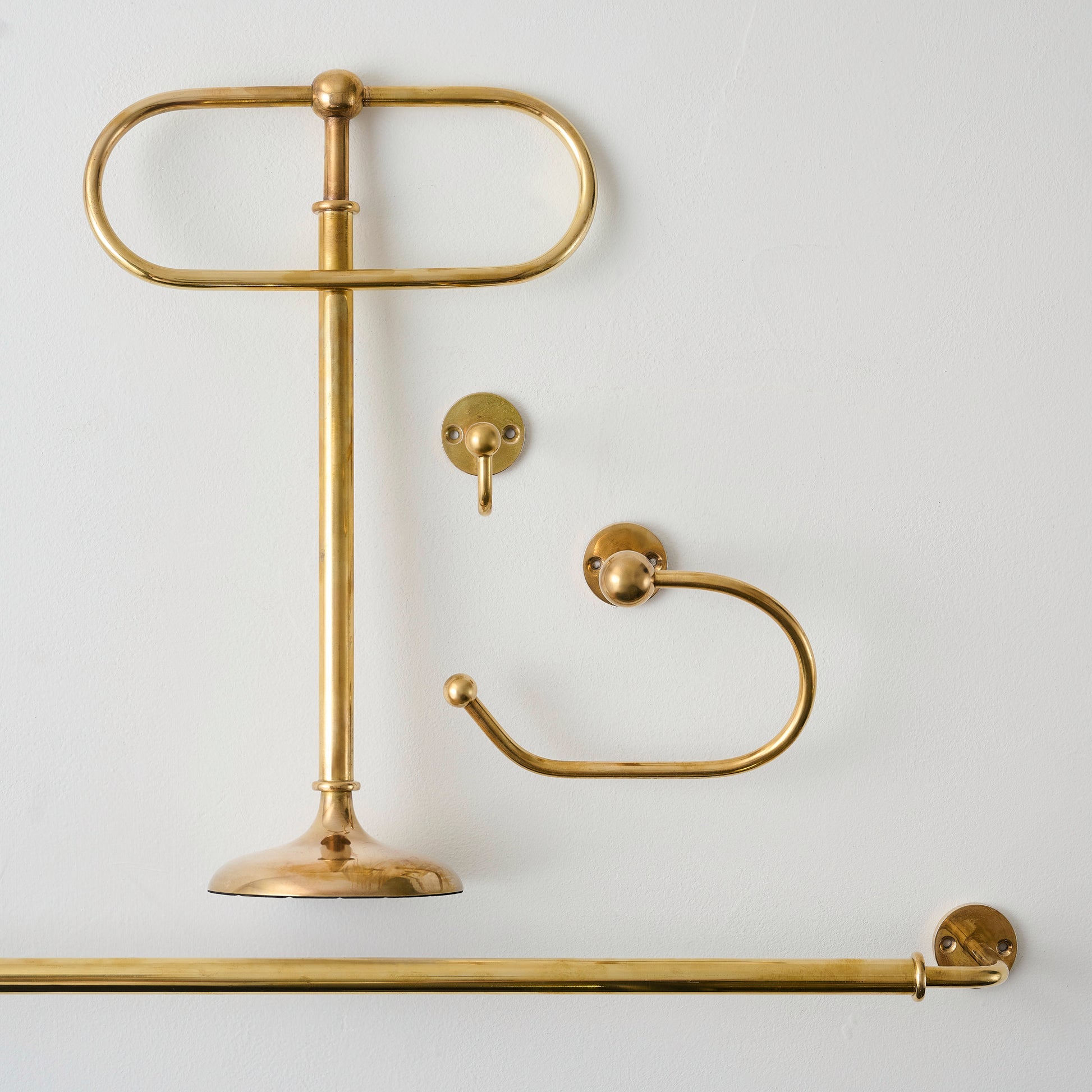Jules Brass Towel Stand shown with hook, bar, and toilet paper holder