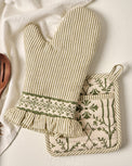 Magnolia Olive Pin Stripe Oven Mitt + Pot Holder Set shown with wooden spoon and tea towel