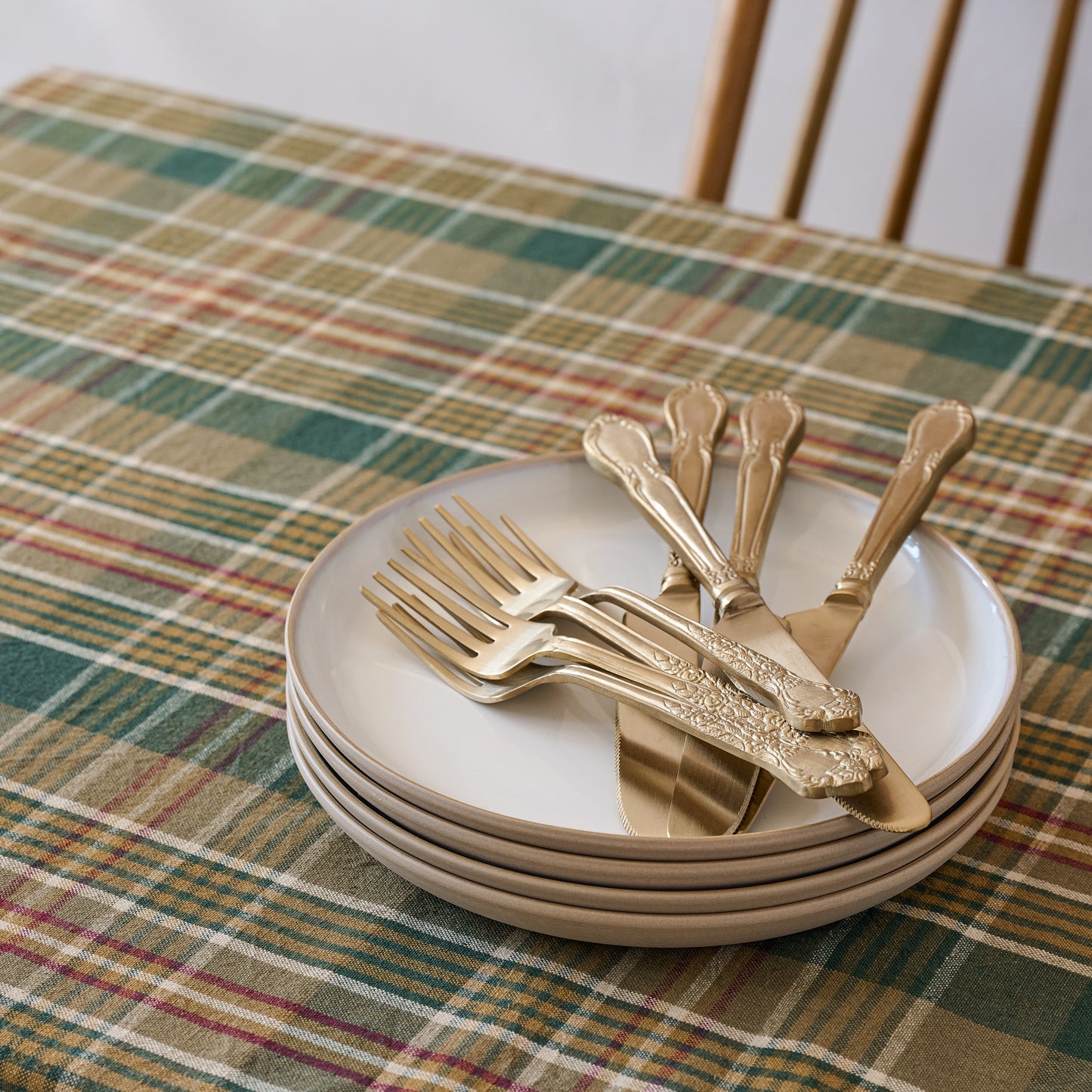 Stone White Lakelynn Plates stacked with flatware on top