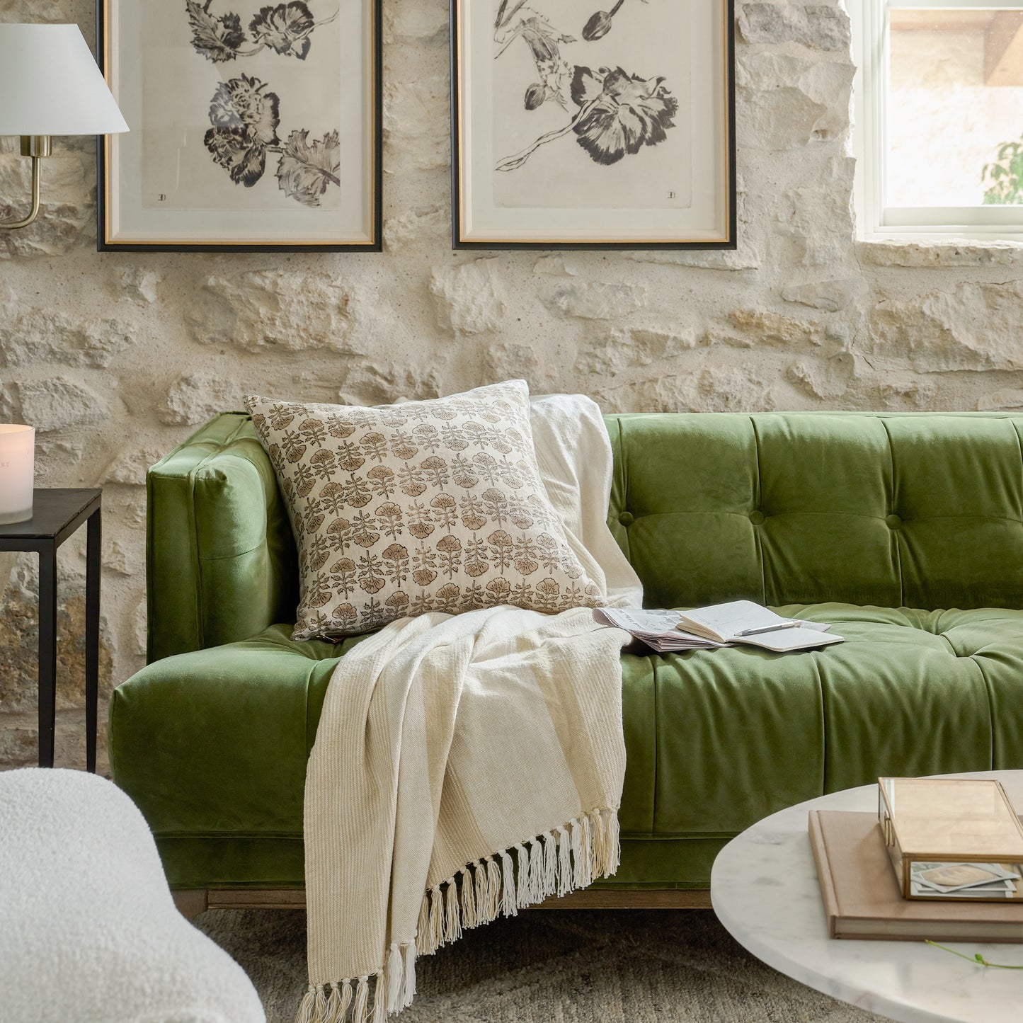 Flora Natural Printed Pillow on a green sofa