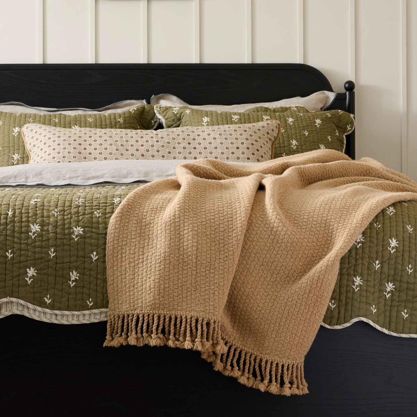 Ochre Basketweave Throw shown draped over corner of bed