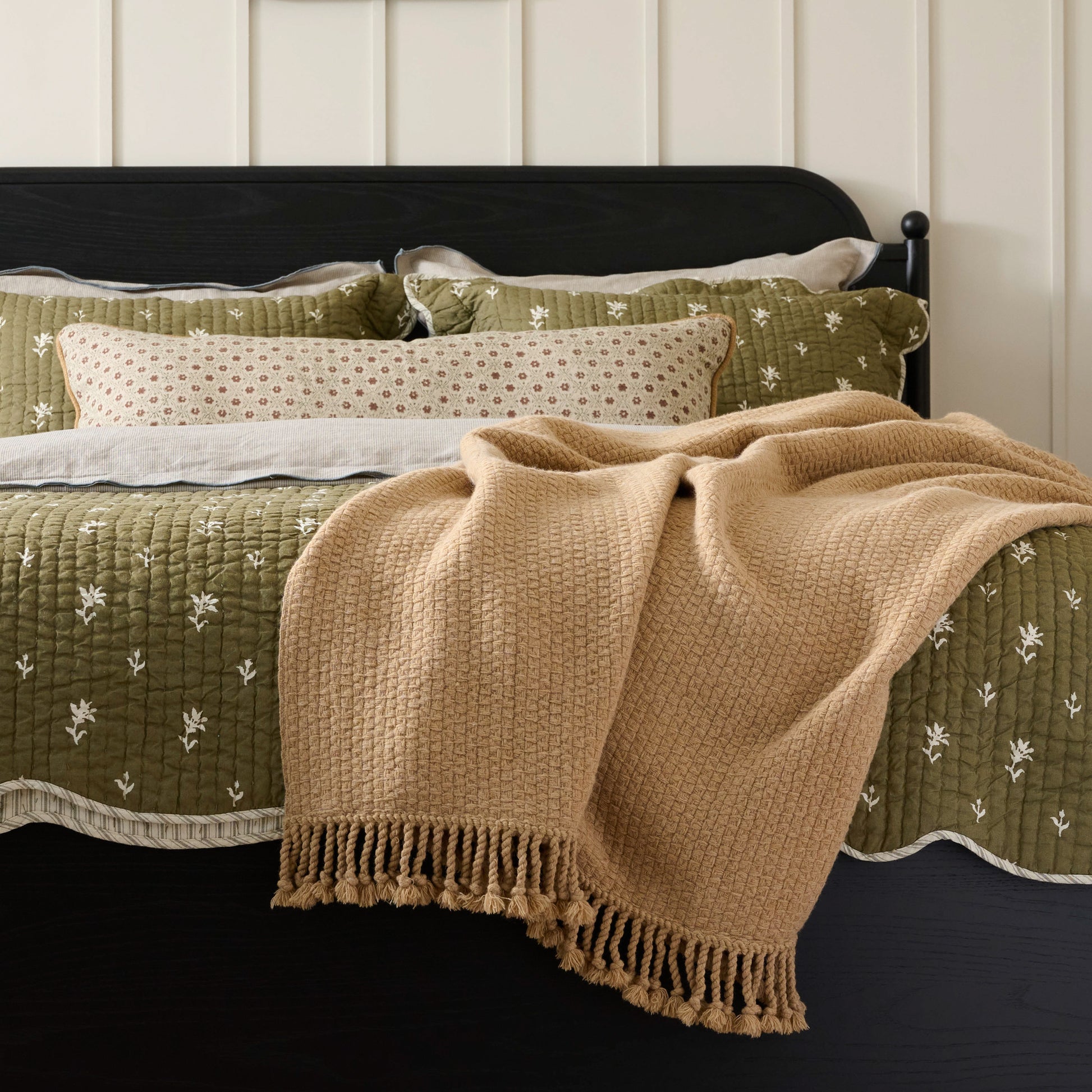 Ochre Basketweave Throw shown draped over corner of bed