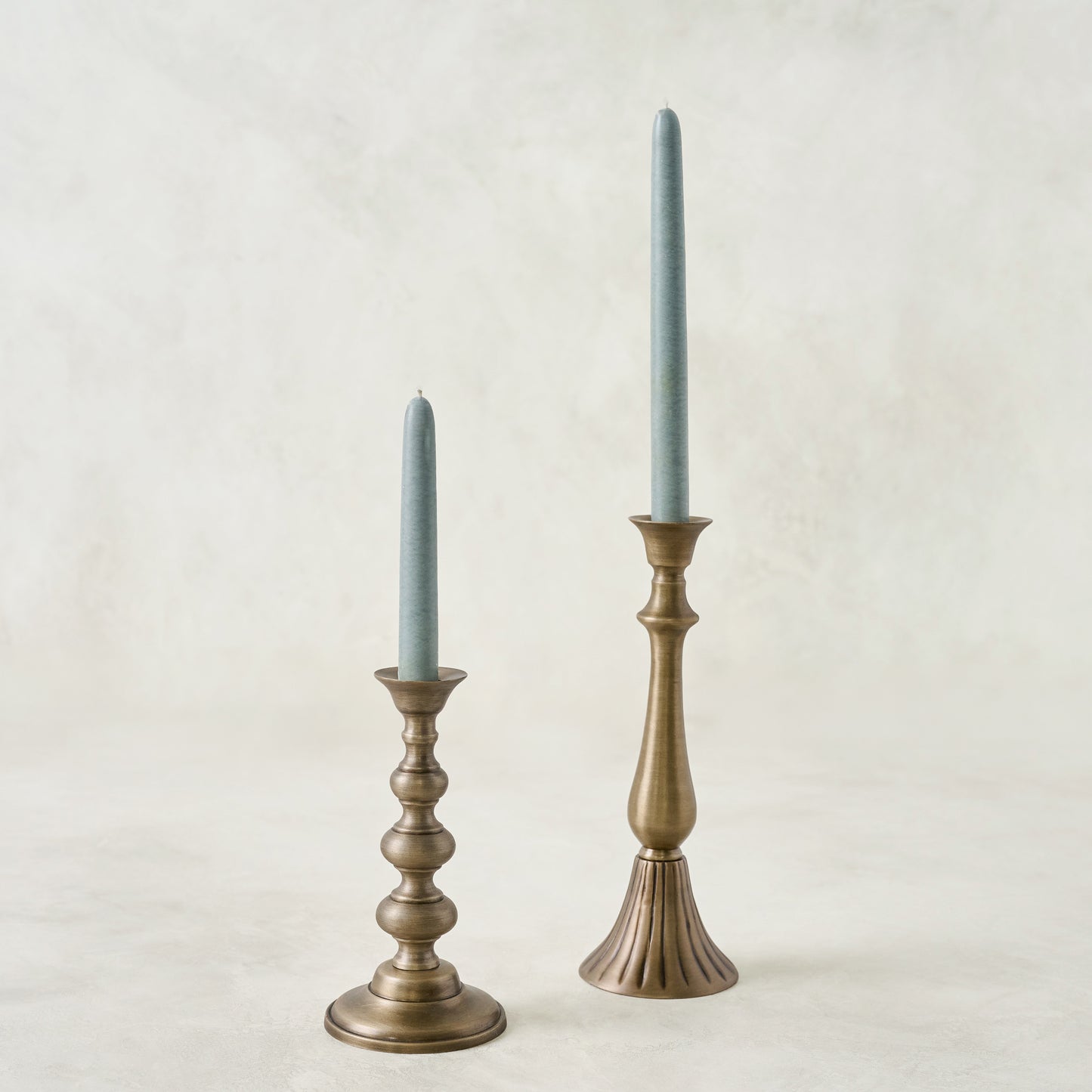 Faris Antiqued Brass Candleholder shown with candles