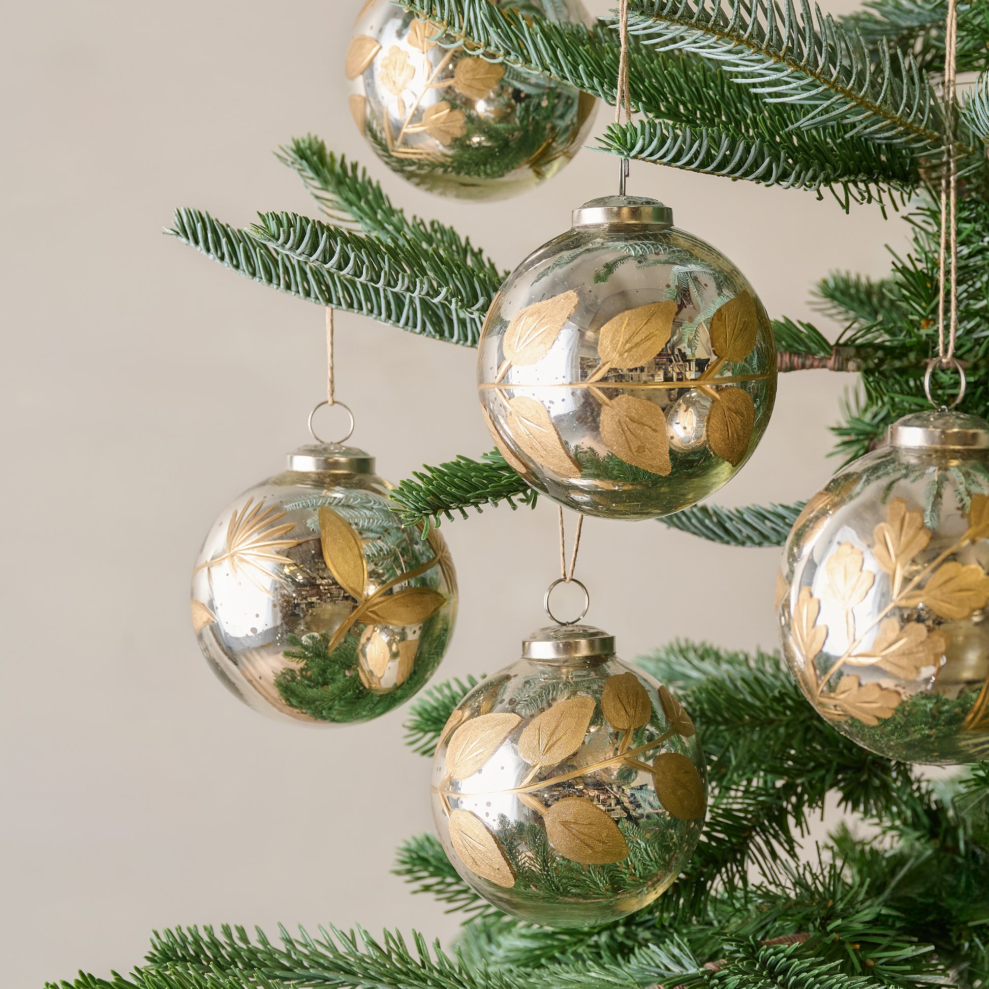Large Mercury Glass and Gold Botanical Ornament Set of Six shown on tree