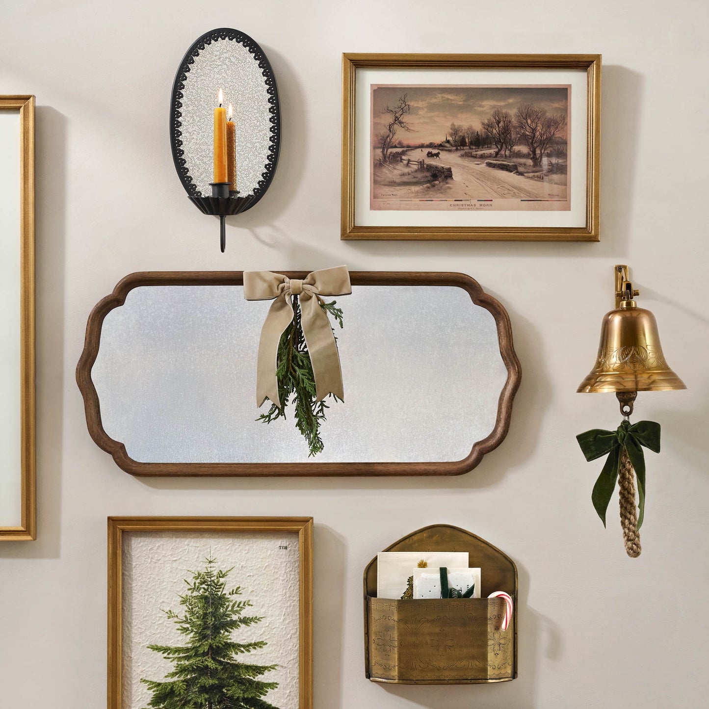 Black Oval Antique Mirrored Sconce in a gallery wall