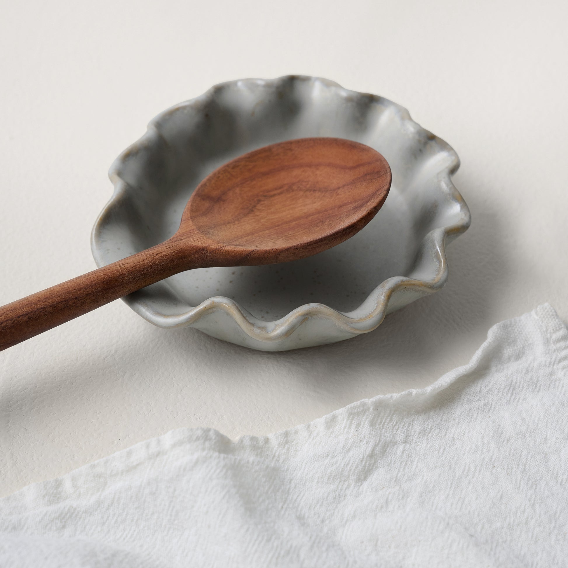 French Grey Ruffle Spoon Rest shown with spoon and tea towel