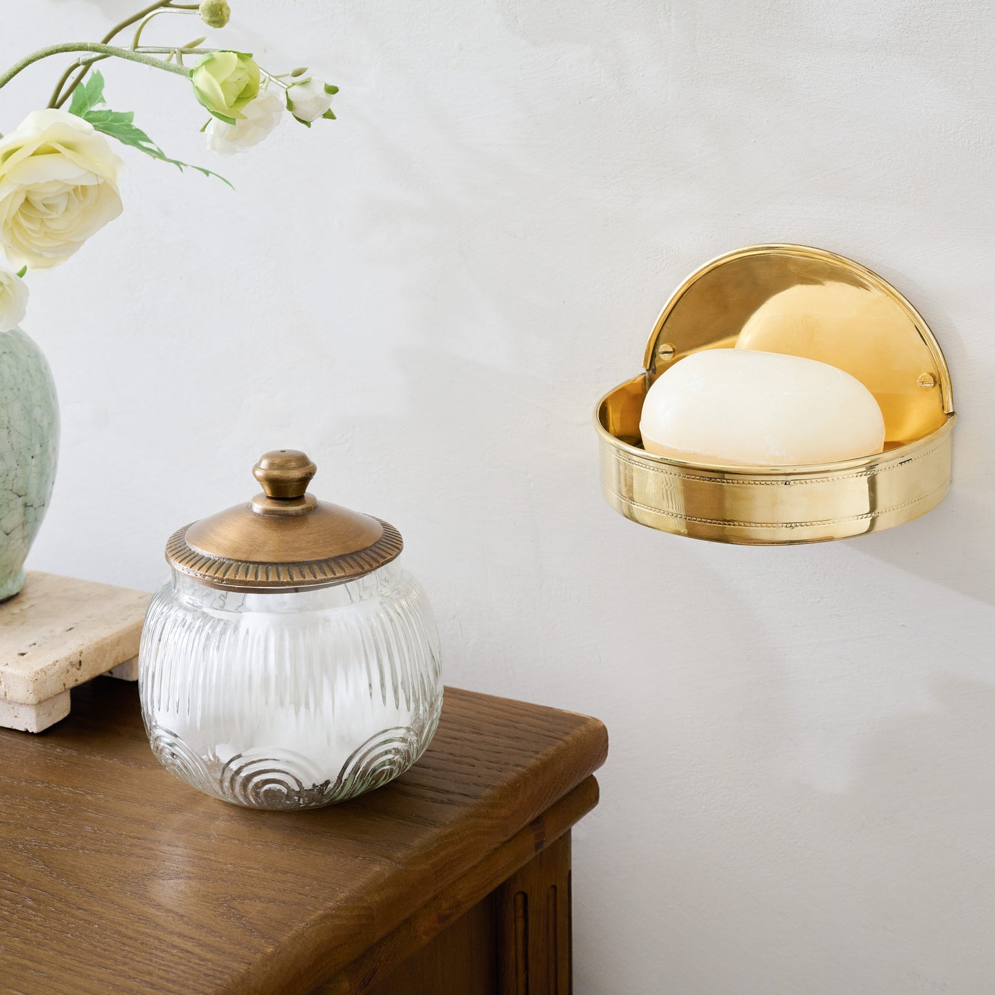 Brass Hanging Soap Dish shown on wall by vanity