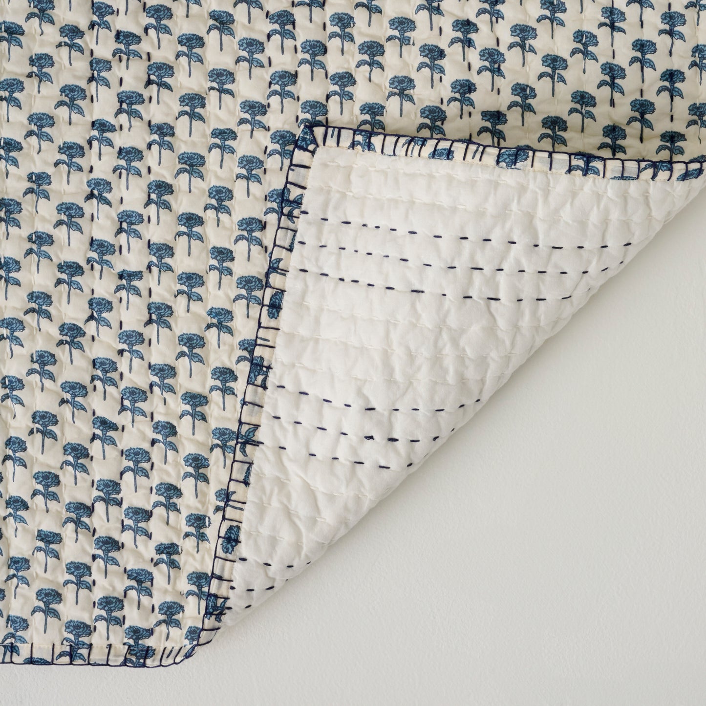Lilianne Floral Printed Quilt shown folded over on corner