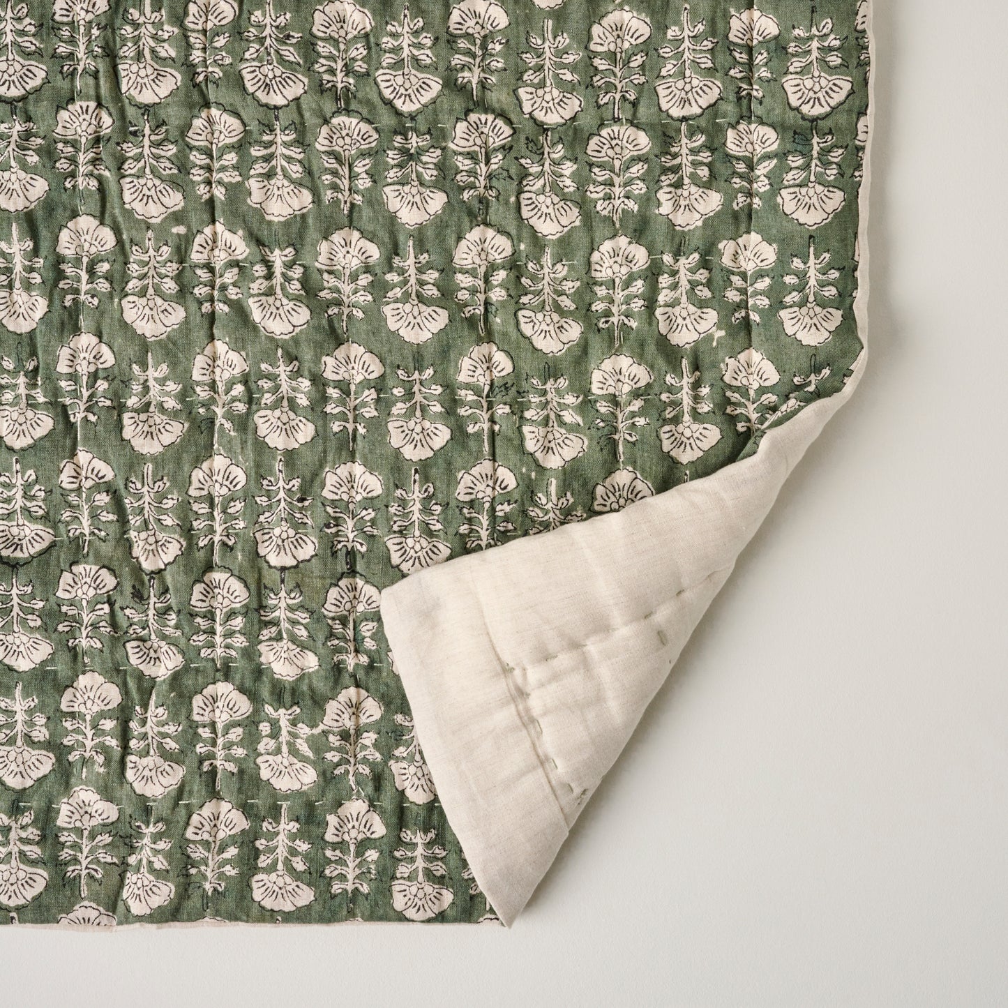 Flora Block Print Quilt - Dusty Green corner shown turned back