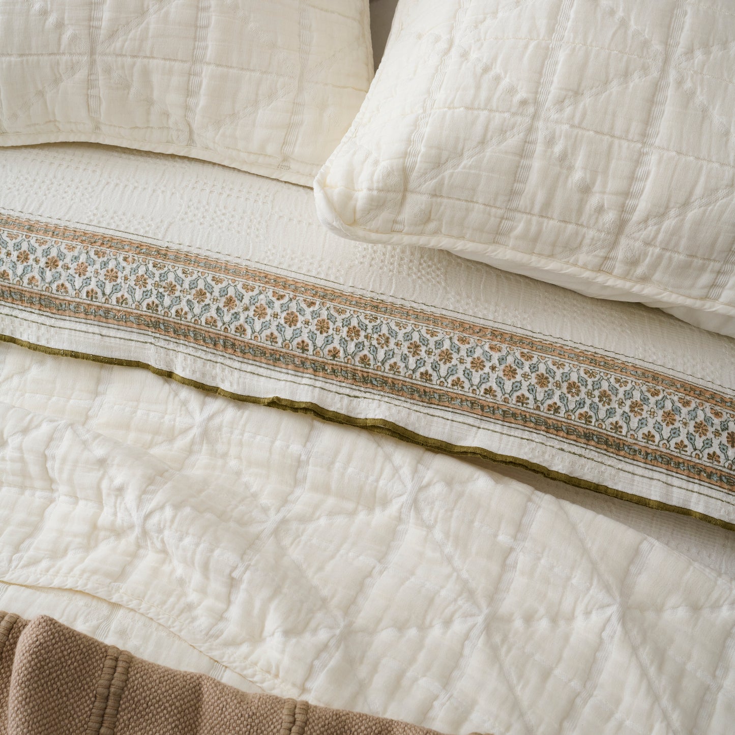 Sutton Cream Matelasse Sham shown on bed with quilt and other bedding