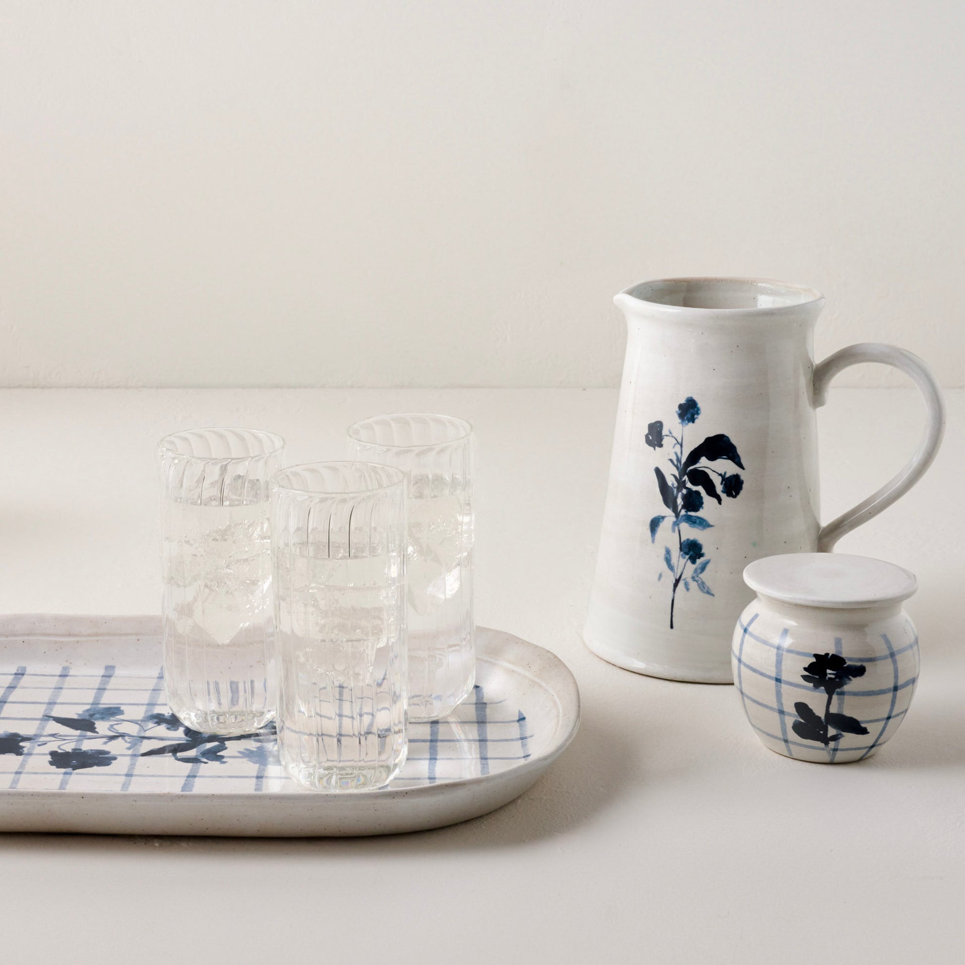 Lila Floral Serving Platter shown with fluted tumblers and other Lila floral product