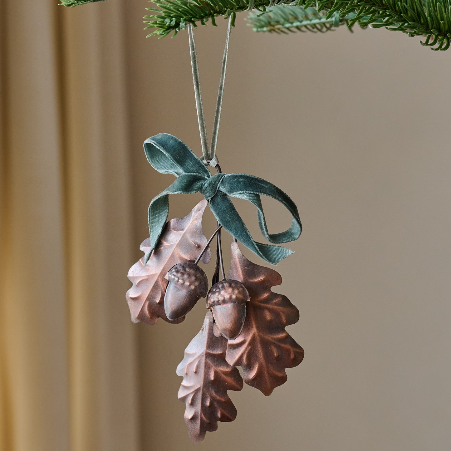 Pressed Metal Oak Leaf Ornament shown hung from tree