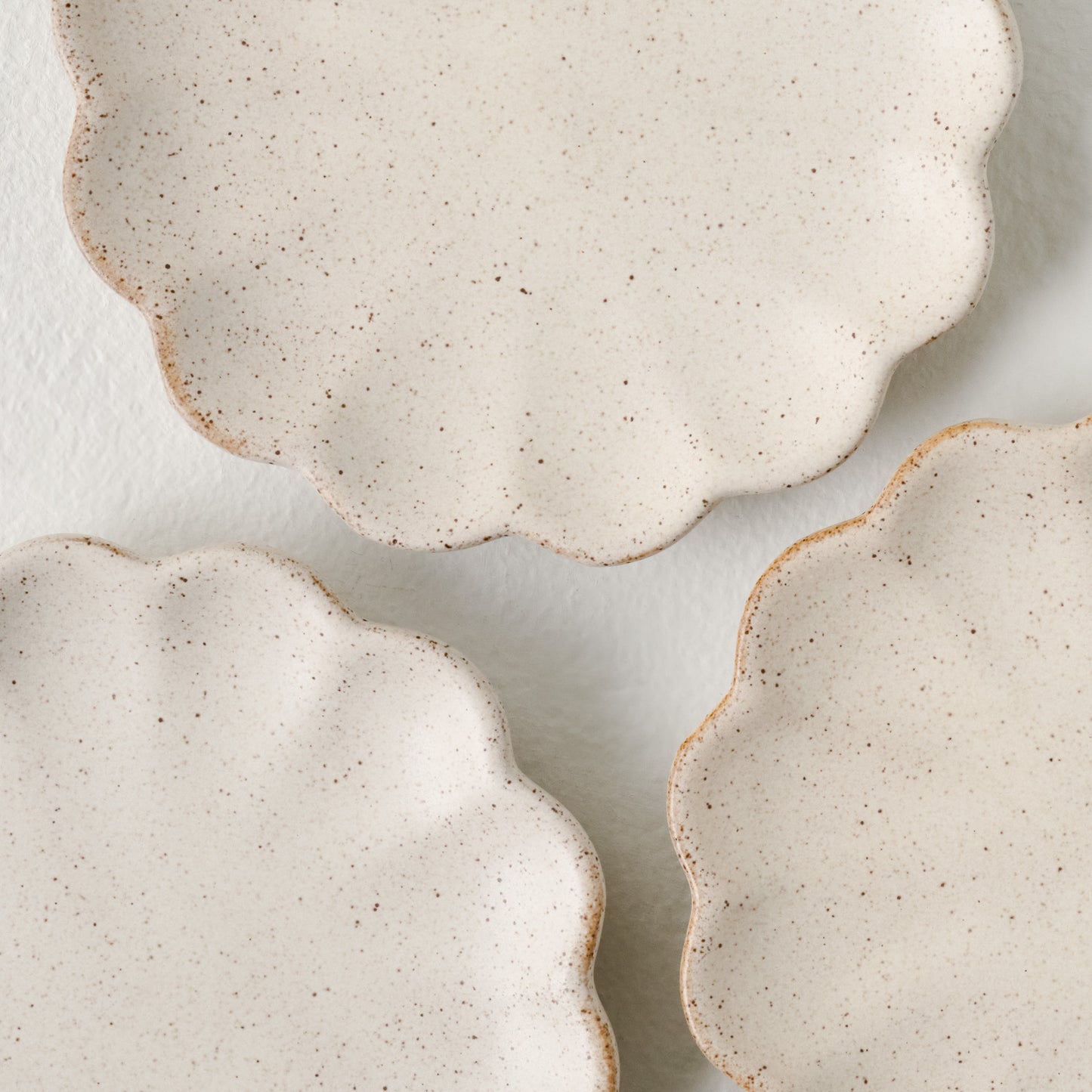 French White Scalloped Edge Stoneware Coaster Set up close