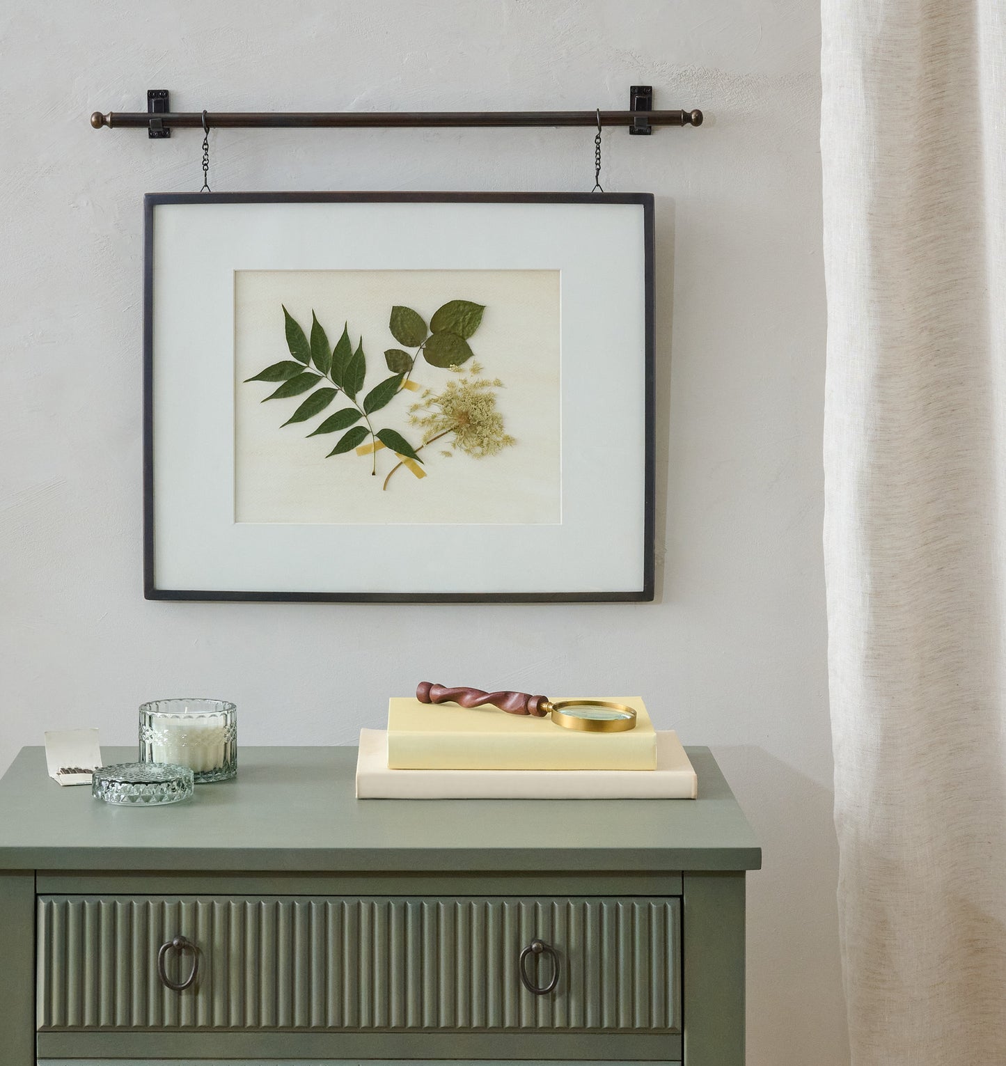 Colleen Antique Bronze Rail Picture Frame shown hung above nightstand